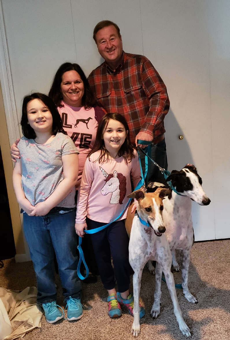 Another Hardee Graduate and a Plus 1 !! Congratulations to Jane, Paul, Kate and Claire with their new "siblings", Sunny (white and fawn) and BRGA's recently sponsored broken leg dog, Lenny! The family waited patiently for several months to take the trip to FL to pick up Nevaeh, now called Sunny from the Hardee Hero Hound program on December 7. Sunny is a sweet, shy little female that was loved by her trainer at Hardee! Jane, Paul and their daughters immediately fell in love with her too! After graduation, the family agreed to take on an extra passenger, Lenny, to be adopted in VA. Well, not halfway through Lenny's ride to VA, the Anderson's knew he was a part of their family! It turns out that Sunny and Lenny are related! Lenny and Sunny have been inseparable ever since! Lenny officially retired with his new family on December 9! Please welcome everyone to the BRGA pack!