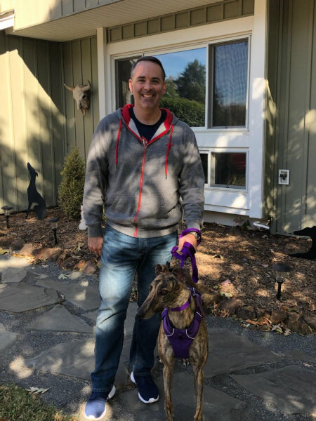 CONGRATULATIONS to Chris and his Greyhound Janis (formerly Wide Open)! Janis, a beautiful red brindle, hitched a ride to VA with some Prison Hound graduates in late September. She raced in FL and won about a dozen races, often coming from behind, but must have decided that hugs, neighborhood walks, and leaning on everyone she meets is a lot more fun. She proved this when she met her new Dad at a recent Meet & Greet and now looks forward to lots of walks and outdoor activities with Chris! Please join us in welcoming Chris and Janis to the BRGA family!