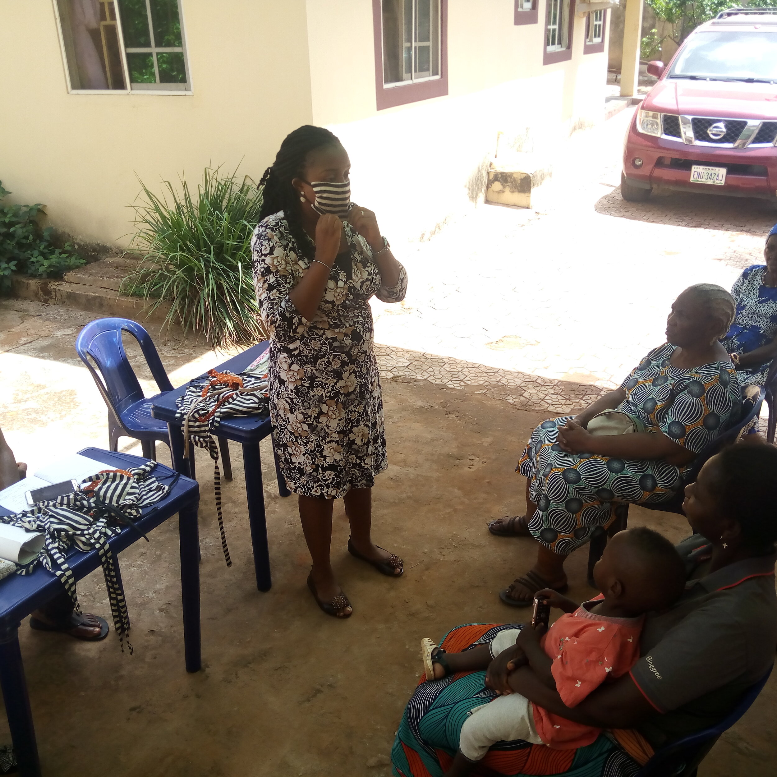 Mrs Evelyn taking participants through how to wear a facemask.jpg