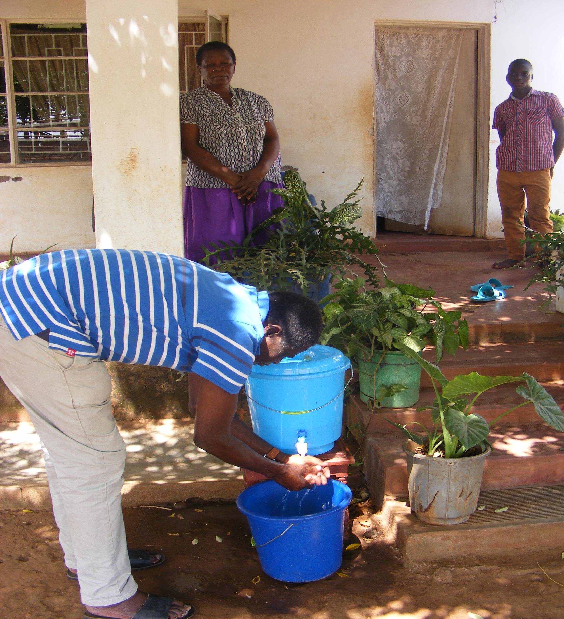 CHICOSUDO EXECUTIVE DIRECTOR DEMONSTRATING HAND WASHING WITH SOAP.jpg