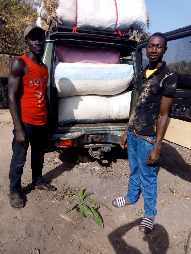  Two Gambian farmers, Bambo (left) and Ustapha, that Gambia Goat Dairy works with. Bambo is growing hay from the peanut crop described below. 