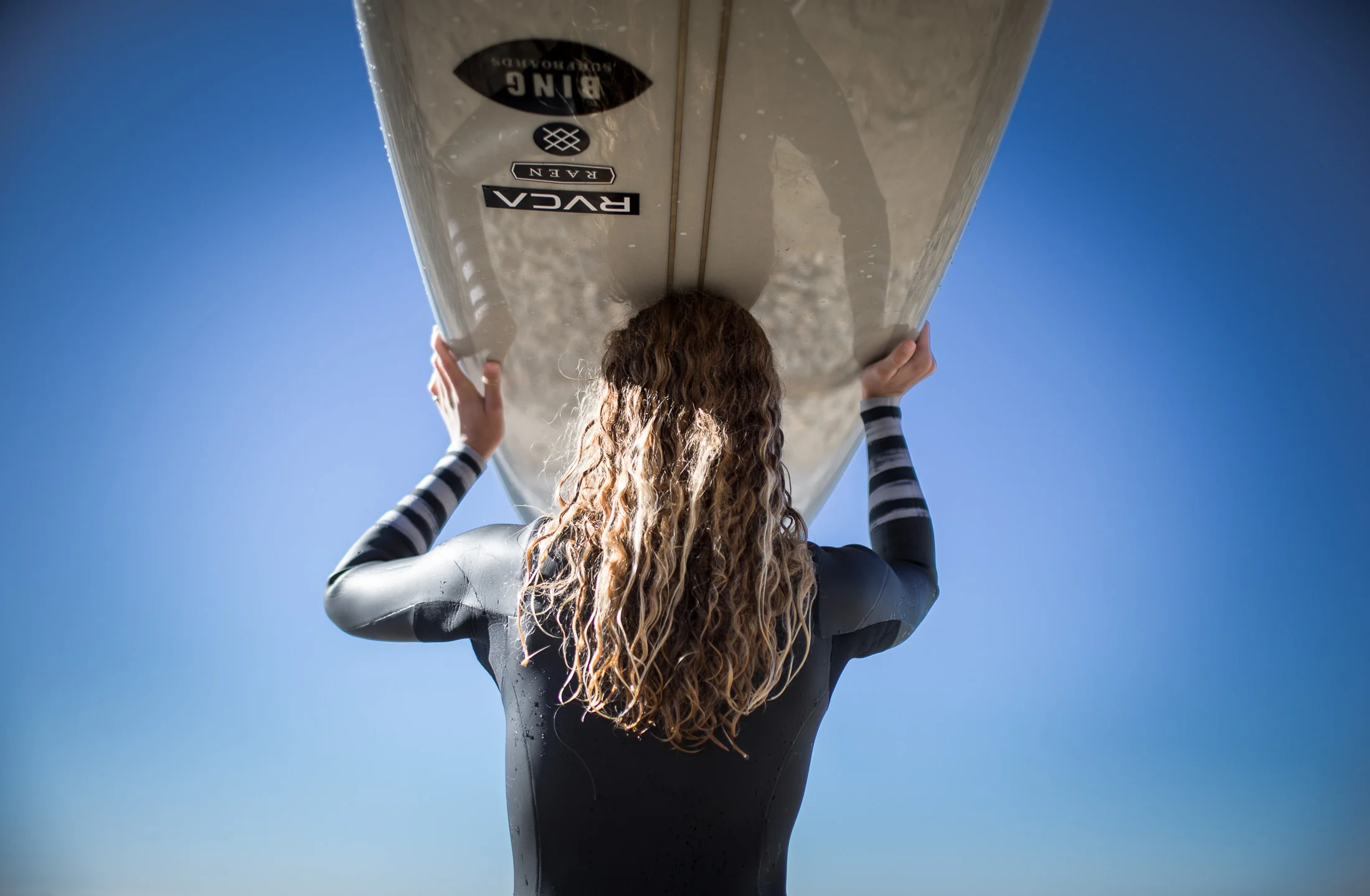 girl holding surf board