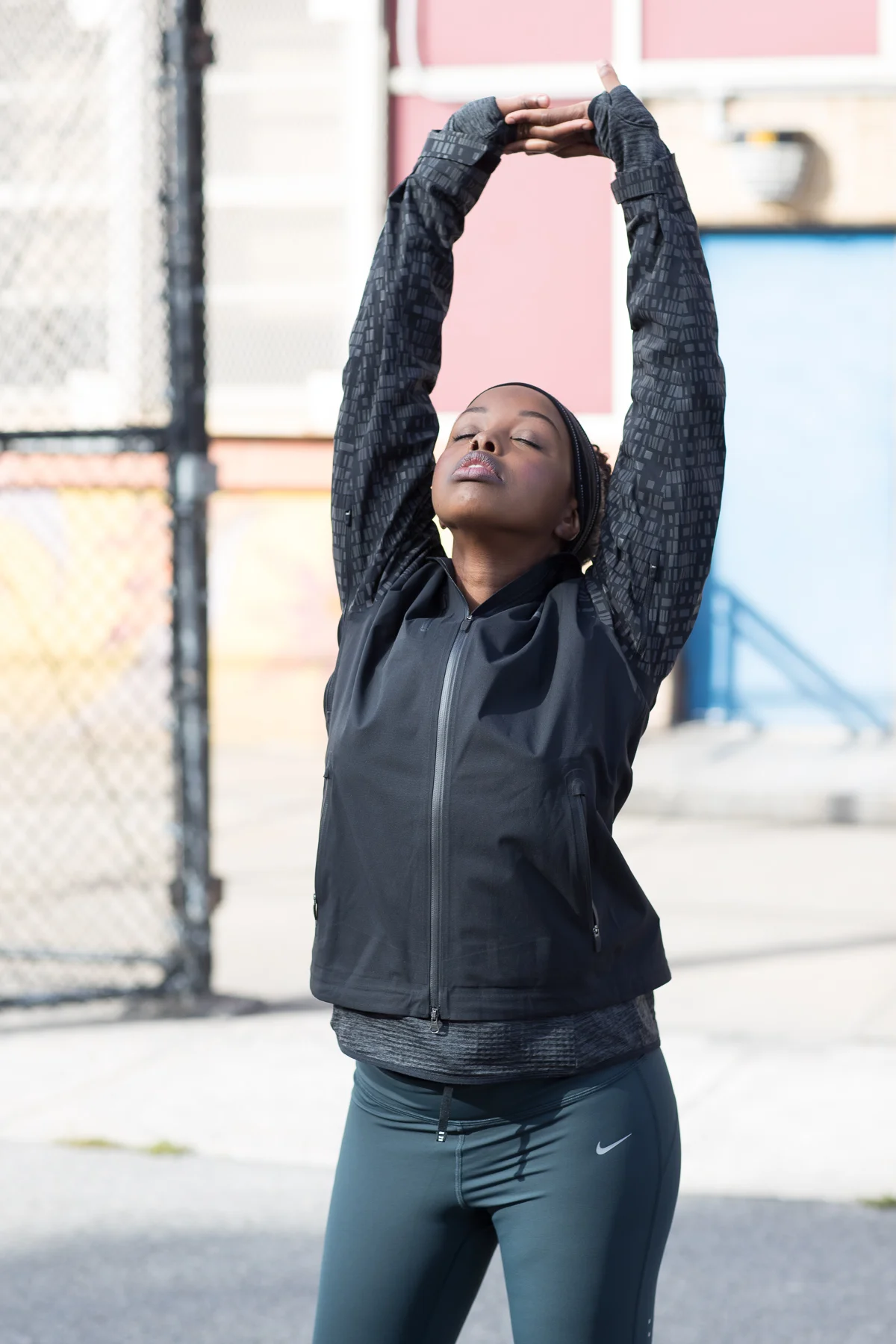 Stretching New York Photographer Ashley Barker Nike Everyday PPL Flash Red Blue Jacket