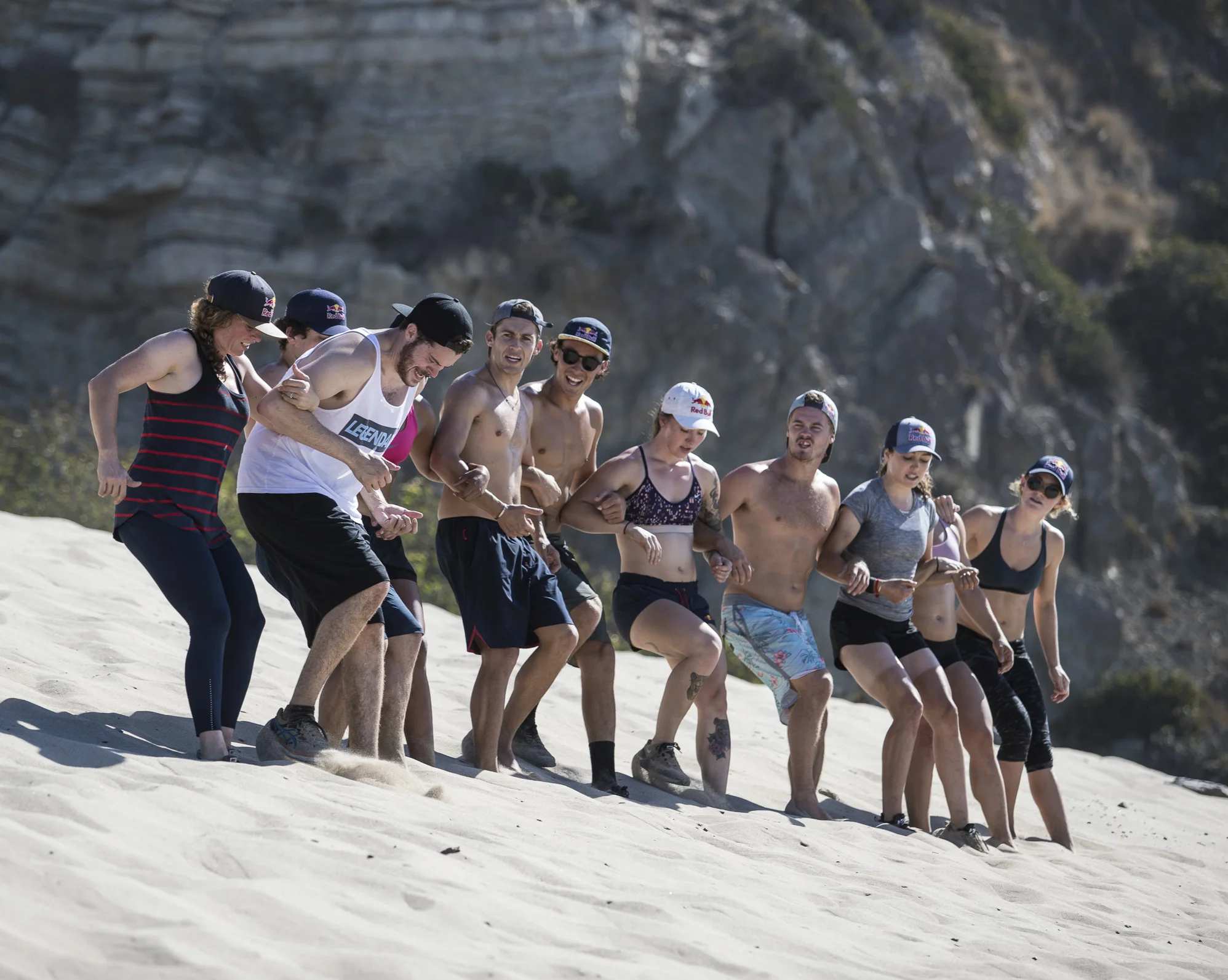 Participants help and encourage Alex Myers to complete a group Seal training exercise during Performing Under Pressure, in Malibu, California October 5 2018