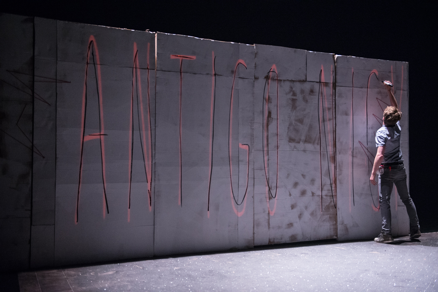 Nick starts the show by writing the name of the play on the wall. Photo by Dahlia Katz