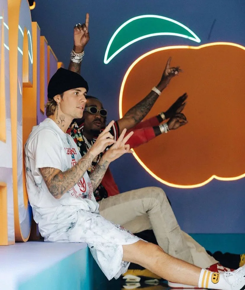 Interactive branded photo moment with custom fruit-shaped scenic backdrop and seating for experiential activation.