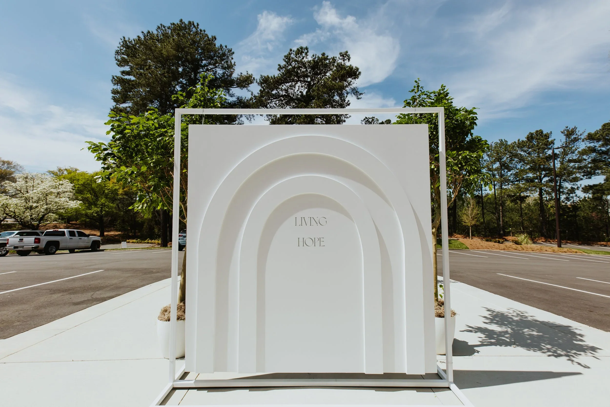 Custom arched photo backdrop with dimensional scenic fabrication for outdoor brand activation.