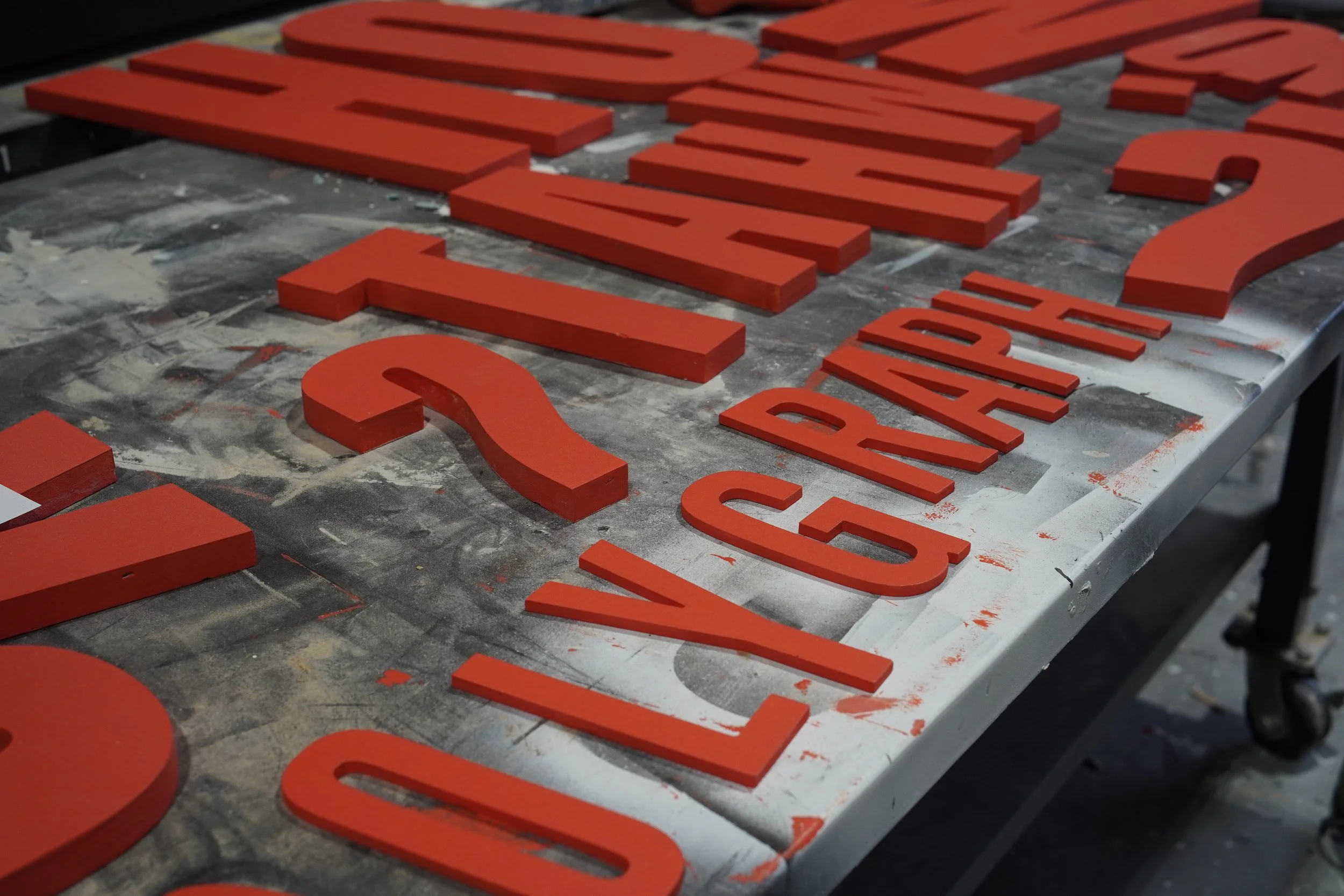 GREENE shop fabrication process with painted dimensional letters for custom event signage.