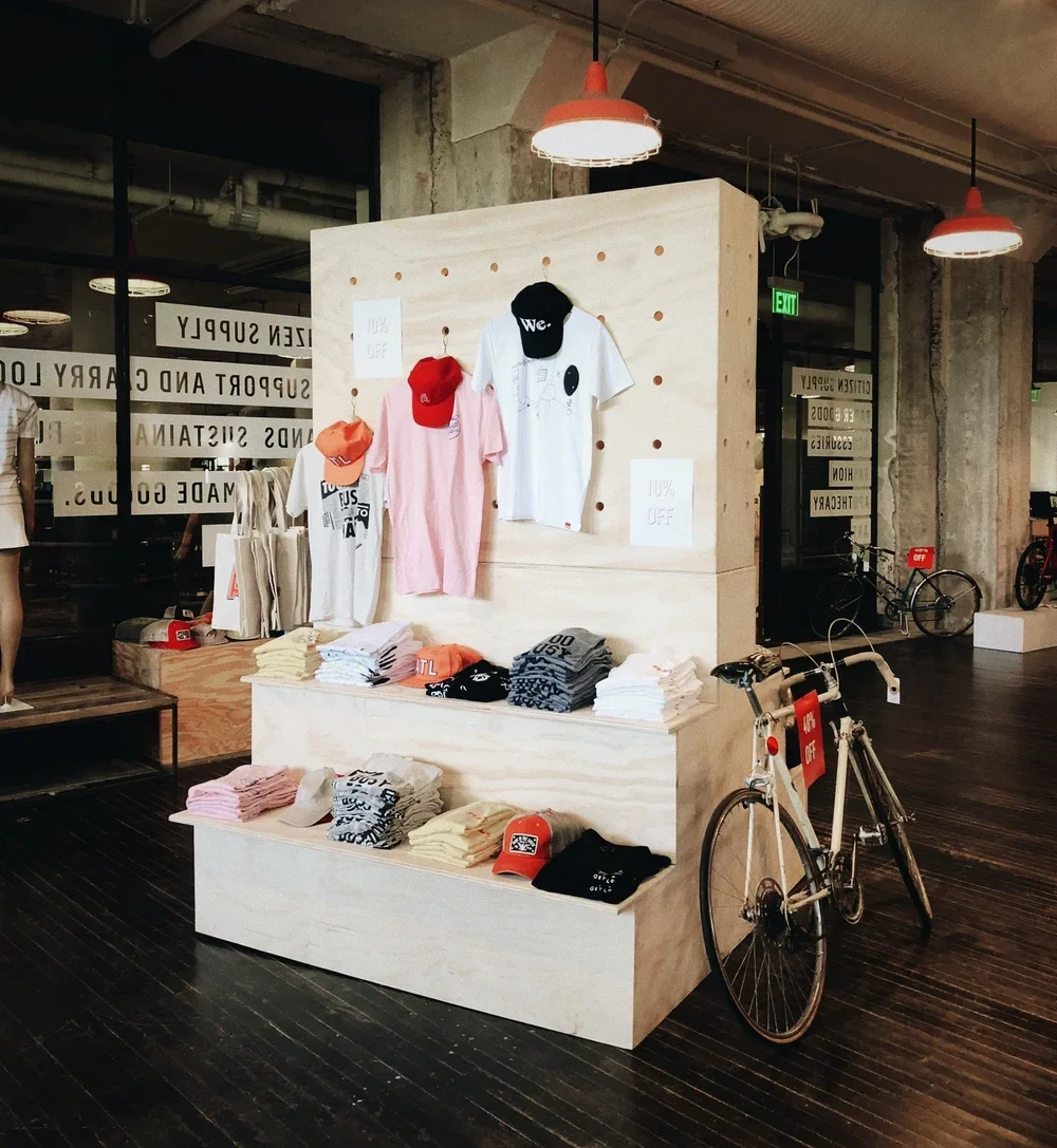Custom wood display for interior store merch - tshirts and hat display - wood pegboard