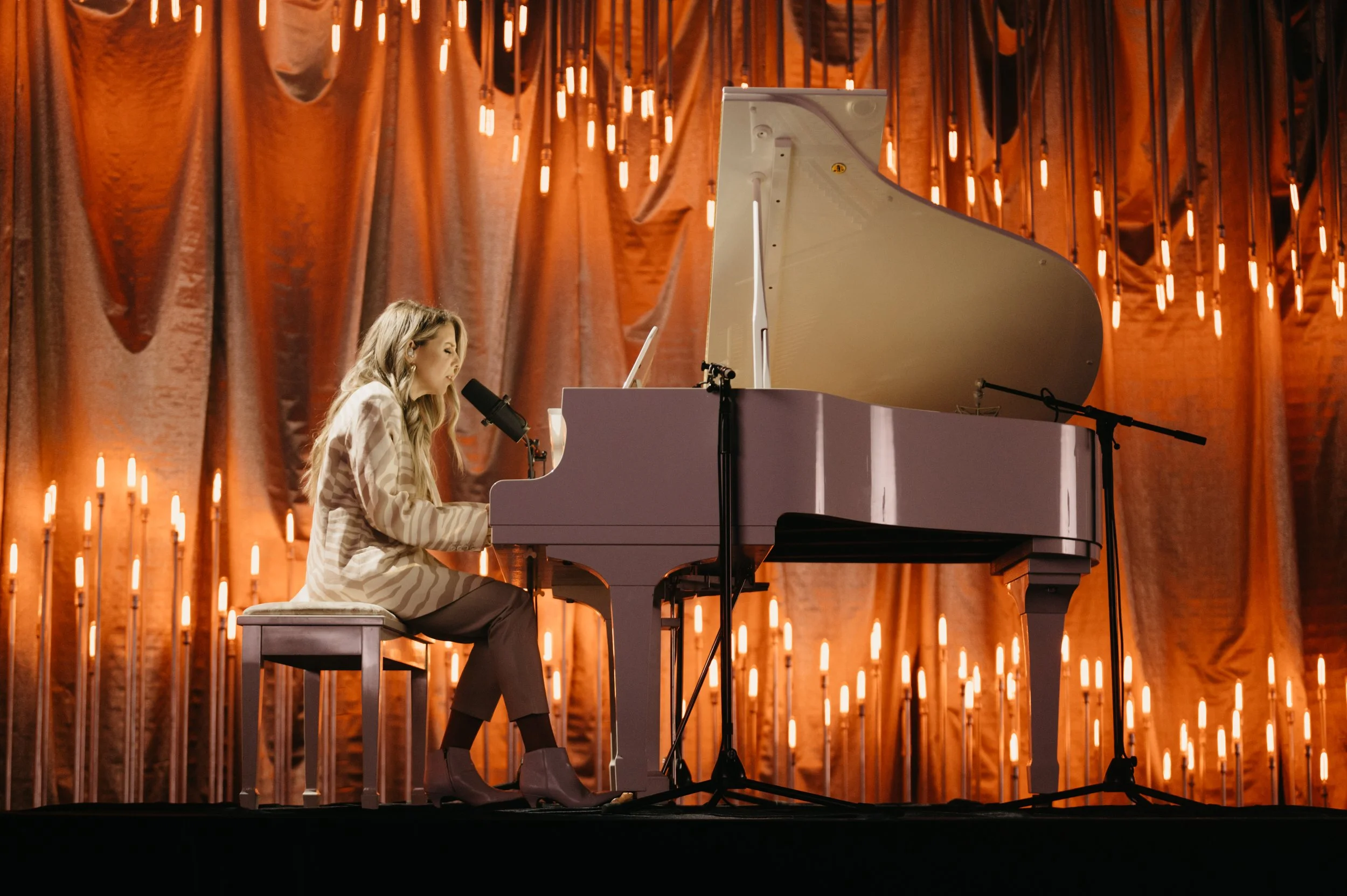 live-performance-stage-with-pink-piano-and-candlelit-scenic-backdrop.jpg