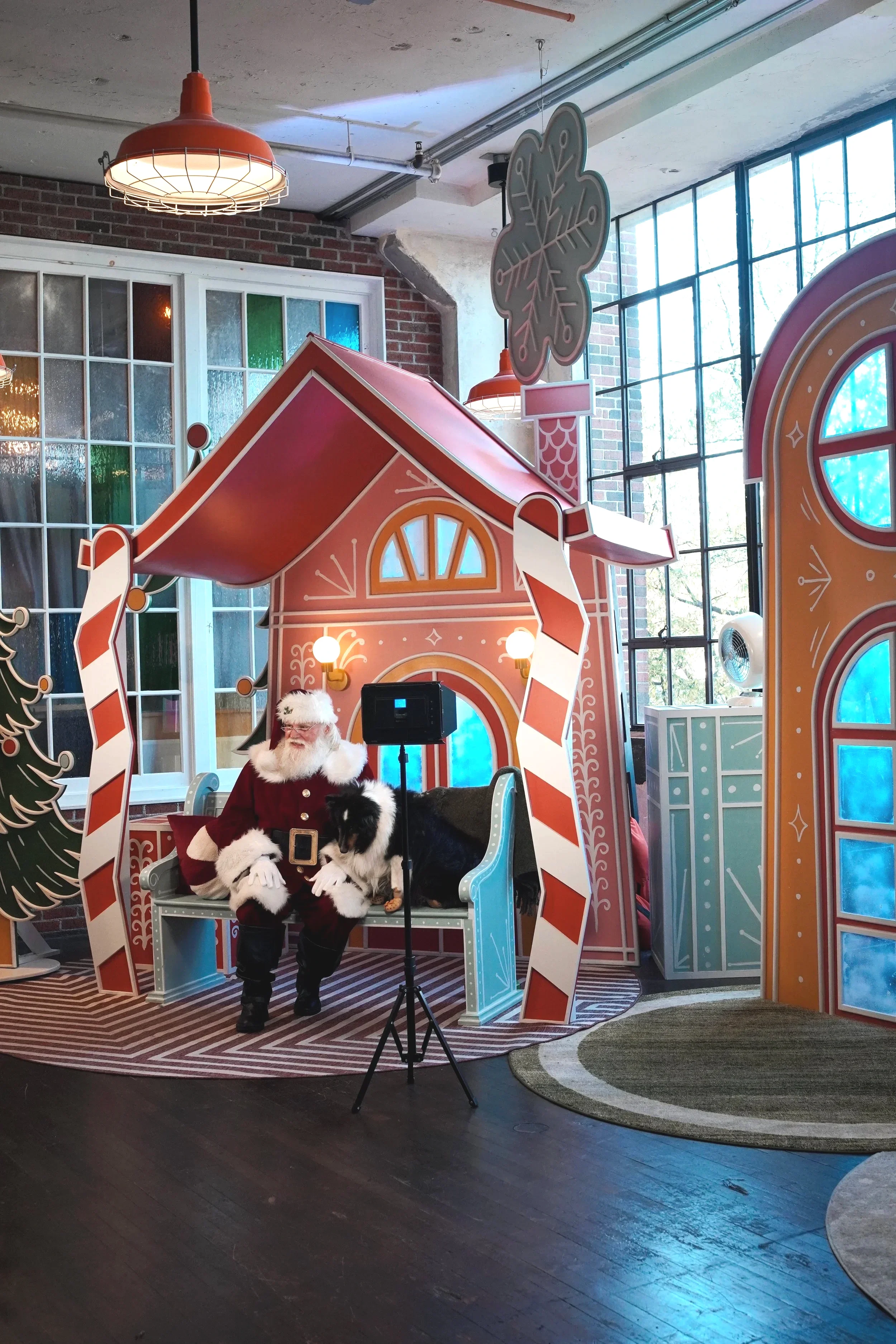 Holiday-themed photo opportunity with custom house facade, scenic backdrop, and built-in photo set.