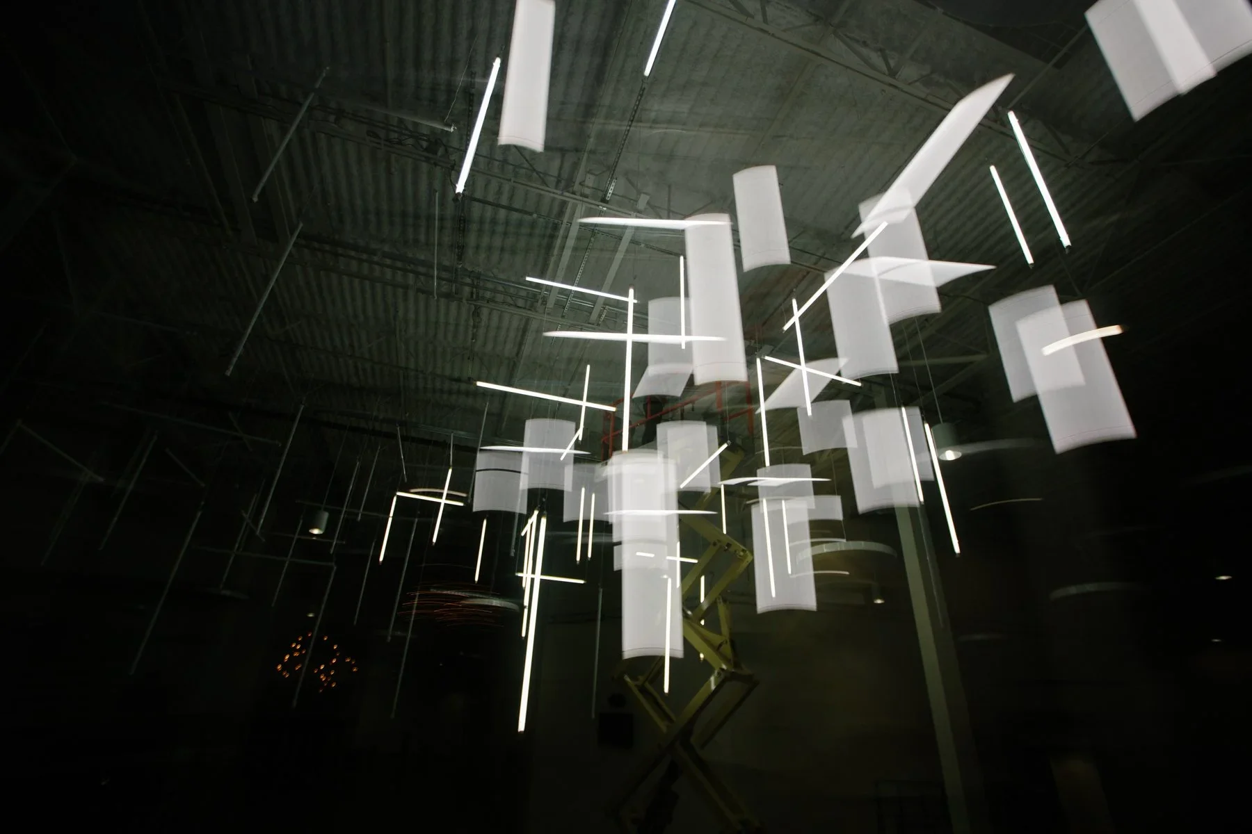 Hanging linear light installation for immersive event environment.