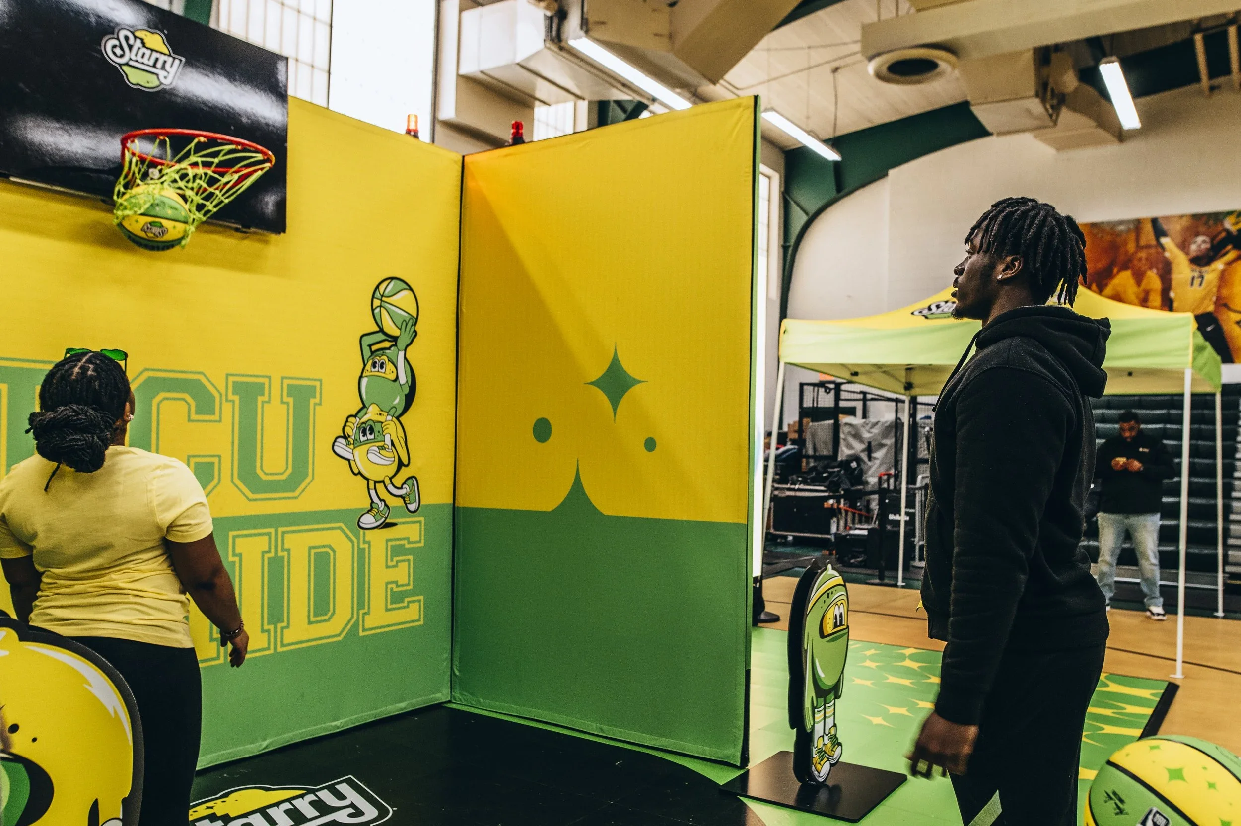 Interactive sports activation with branded basketball game, custom walls, and visitor engagement display.