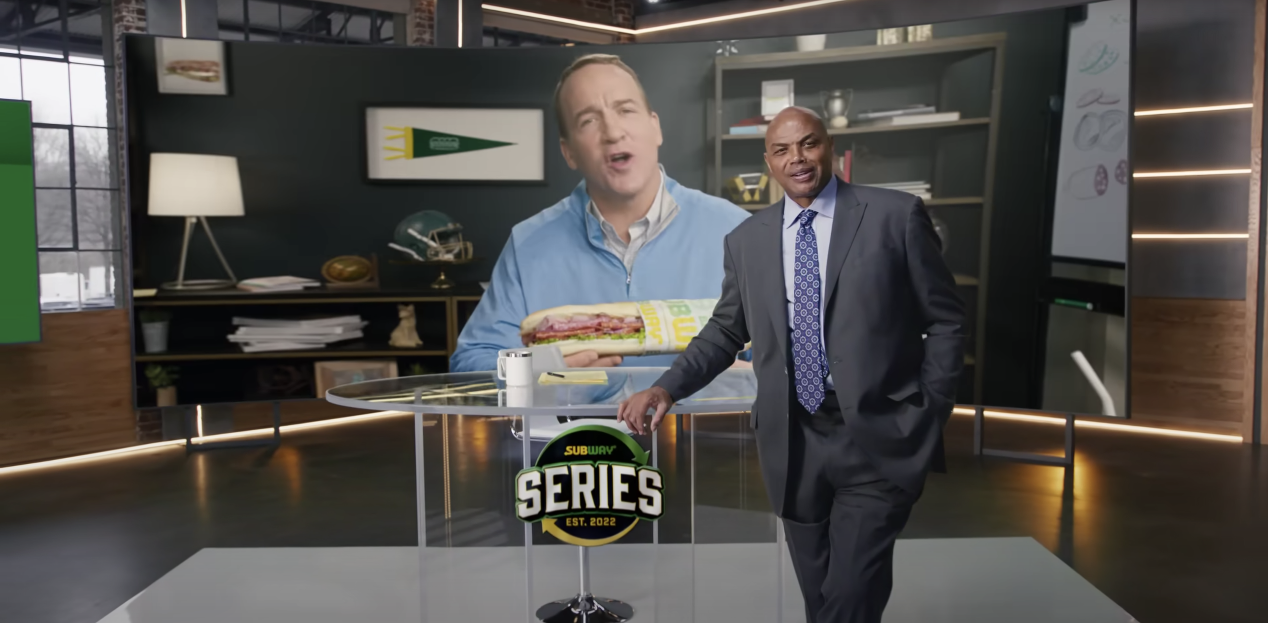Branded broadcast set with custom scenic fabrication, product display, and studio backdrop.