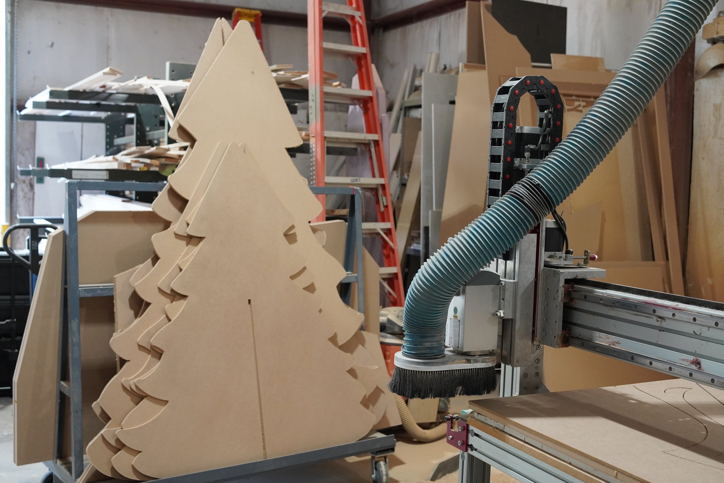 CNC-cut Christmas tree scenic element in the GREENE fabrication shop during production.