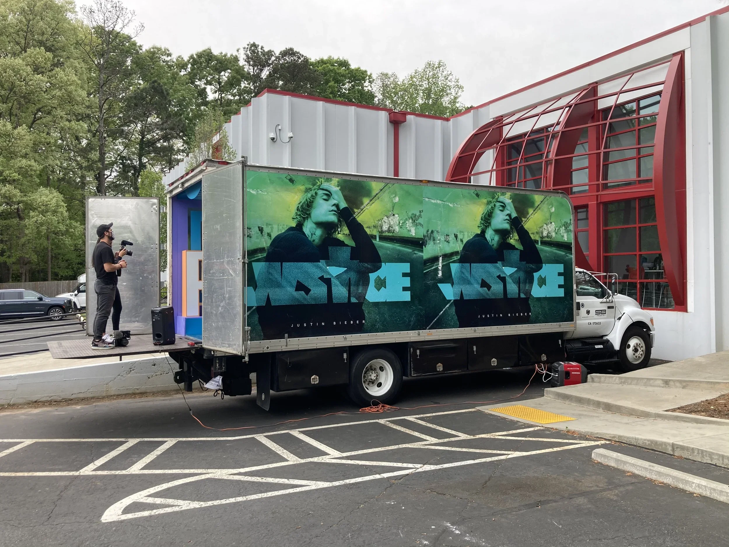 Mobile brand activation truck with custom exterior graphics and interactive video display.