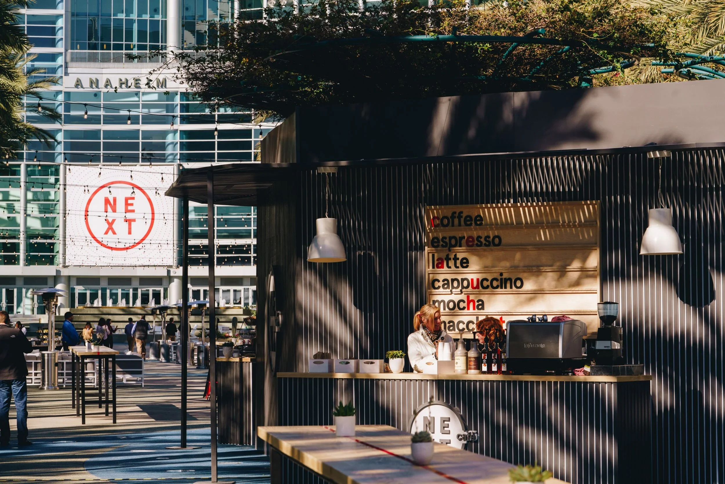 Outdoor pop-up coffee kiosk with custom counter, menu signage, and temporary retail display design.