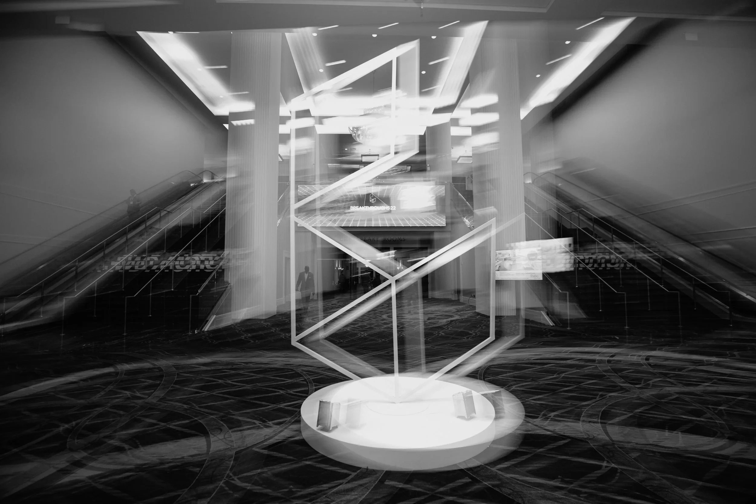 Custom sculptural centerpiece with illuminated scenic elements for corporate event environment.