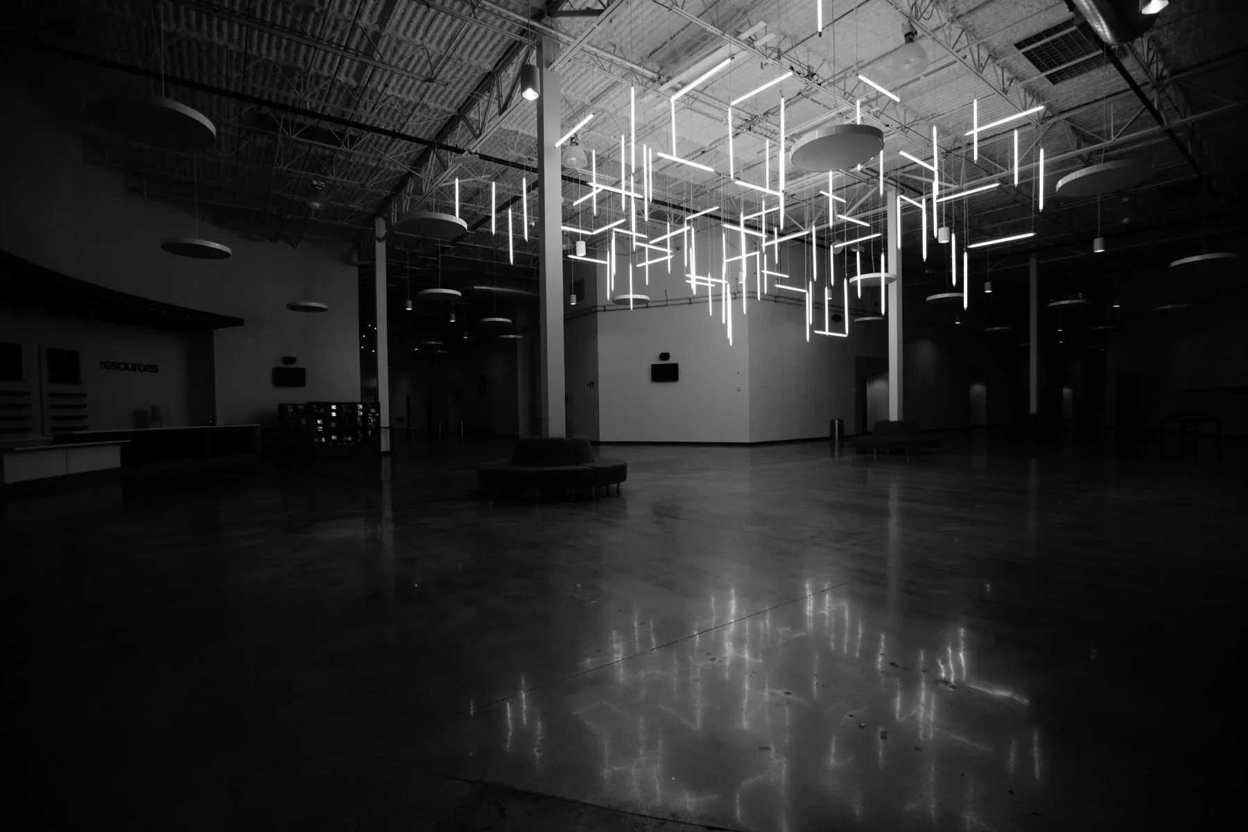 Suspended light installation in gallery-style experiential environment.