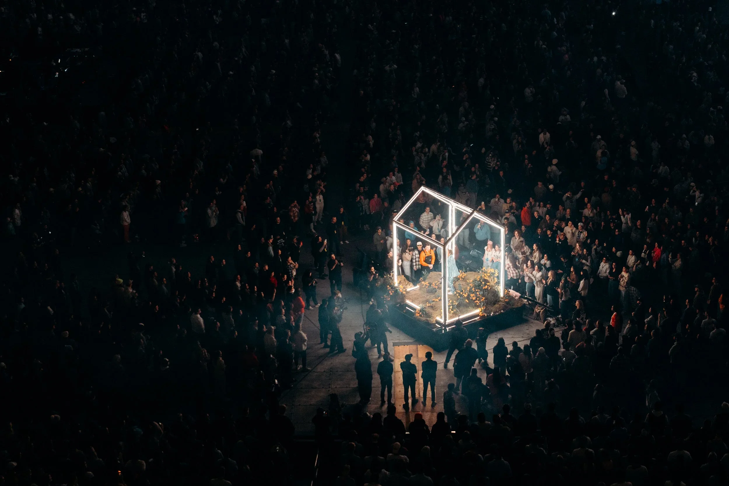 Illuminated house-shaped scenic structure built for a large live event audience.