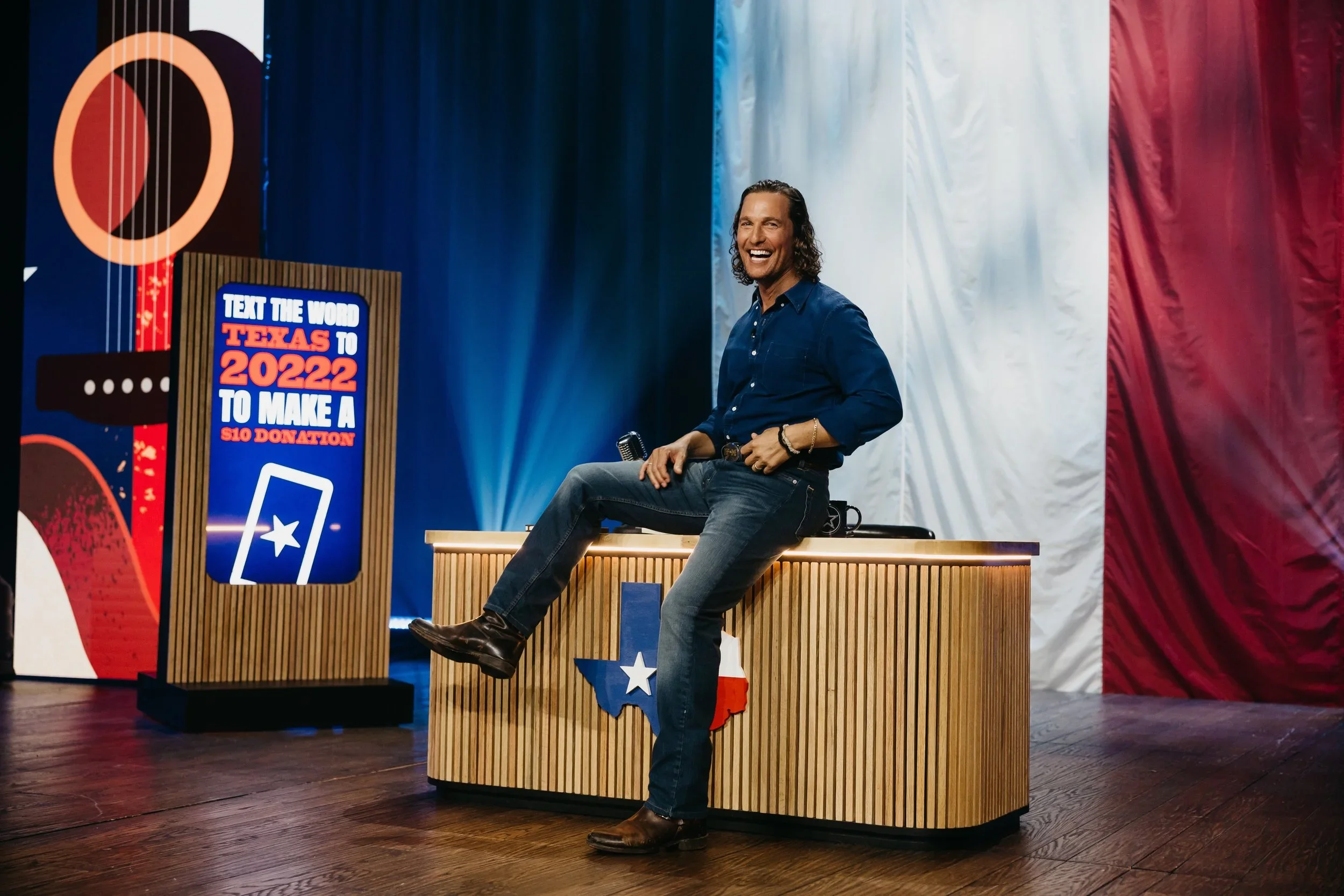 Custom speaker stage with fabricated podium, branded signage, and scenic backdrop.