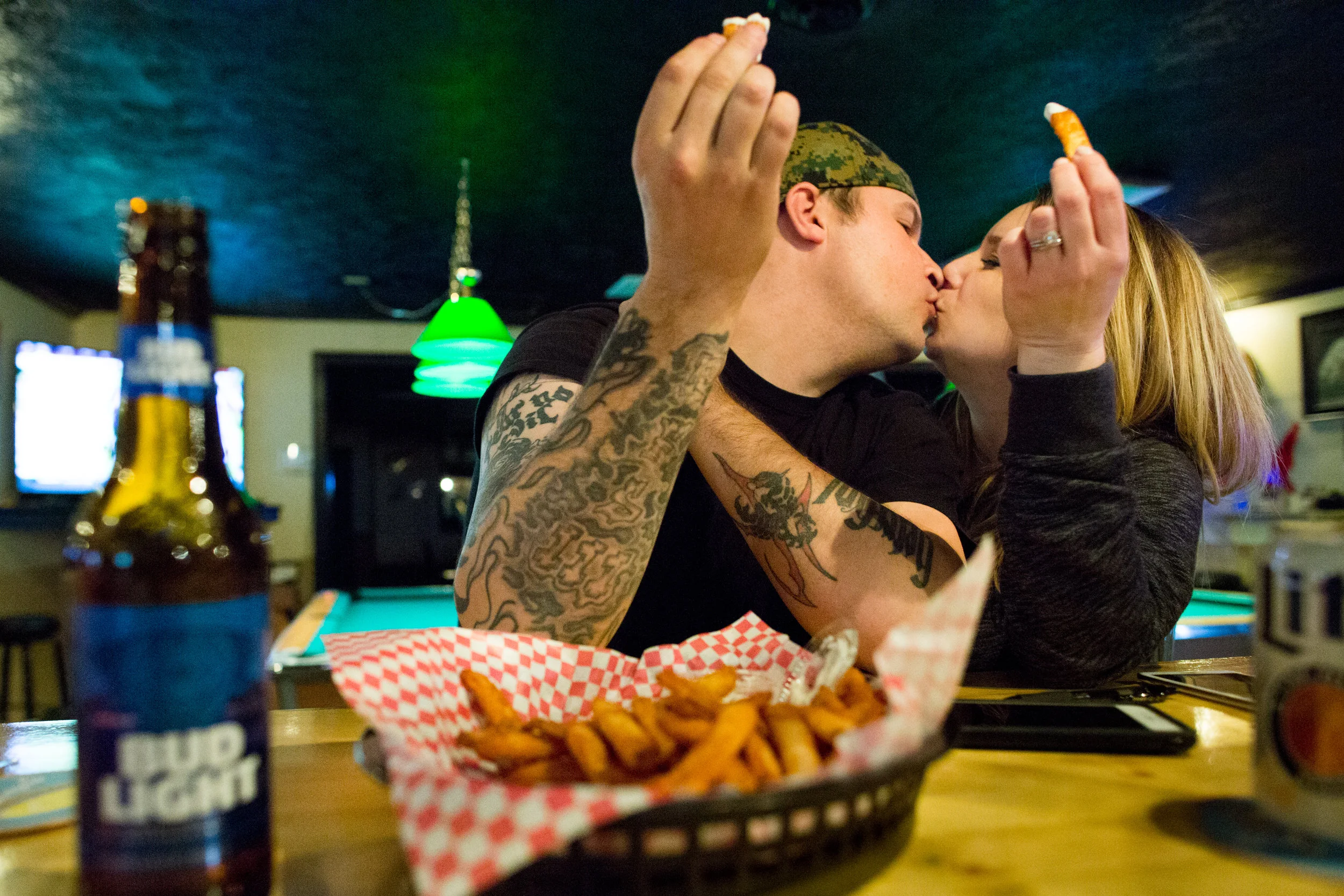 Pete Shumiloff, 34, and Alisha Dalton, 27, they still share their kisses, fries and Bud Light at the Mason Jar in Morgantown, W. Va.. Neither planned to boycott the beer.
