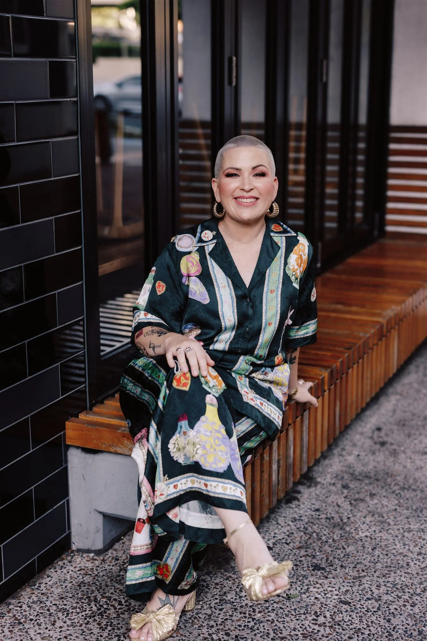 Portrait of Brisbane Marriage Celebrant Erin Woodhall looking at the camera and smiling while sitting down