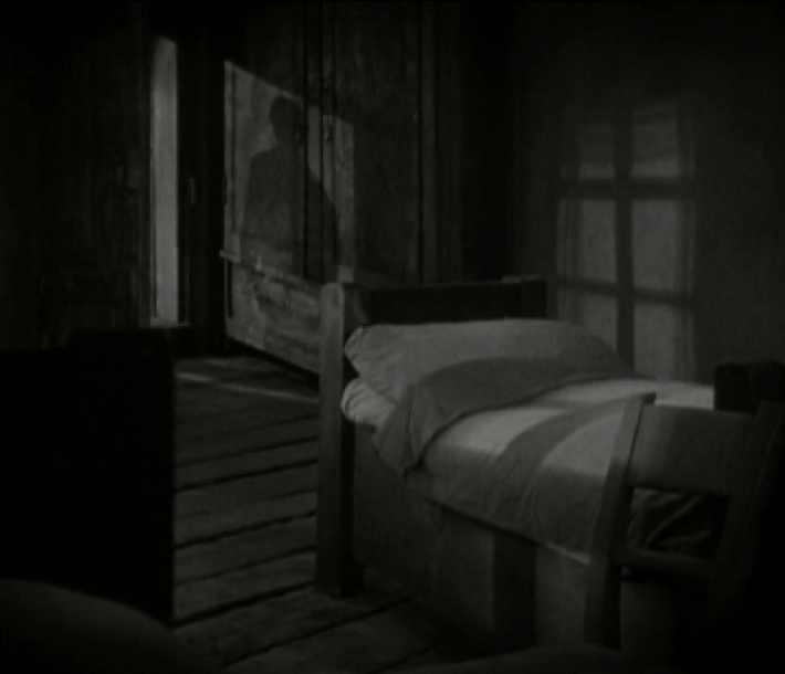 Image 2. A strong silhouette is cast on the wardrobe placed in the background.