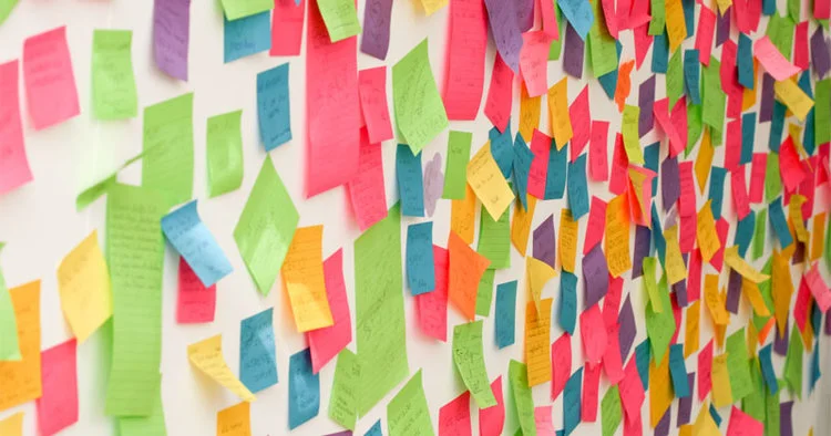 A wall covered in post-it notes