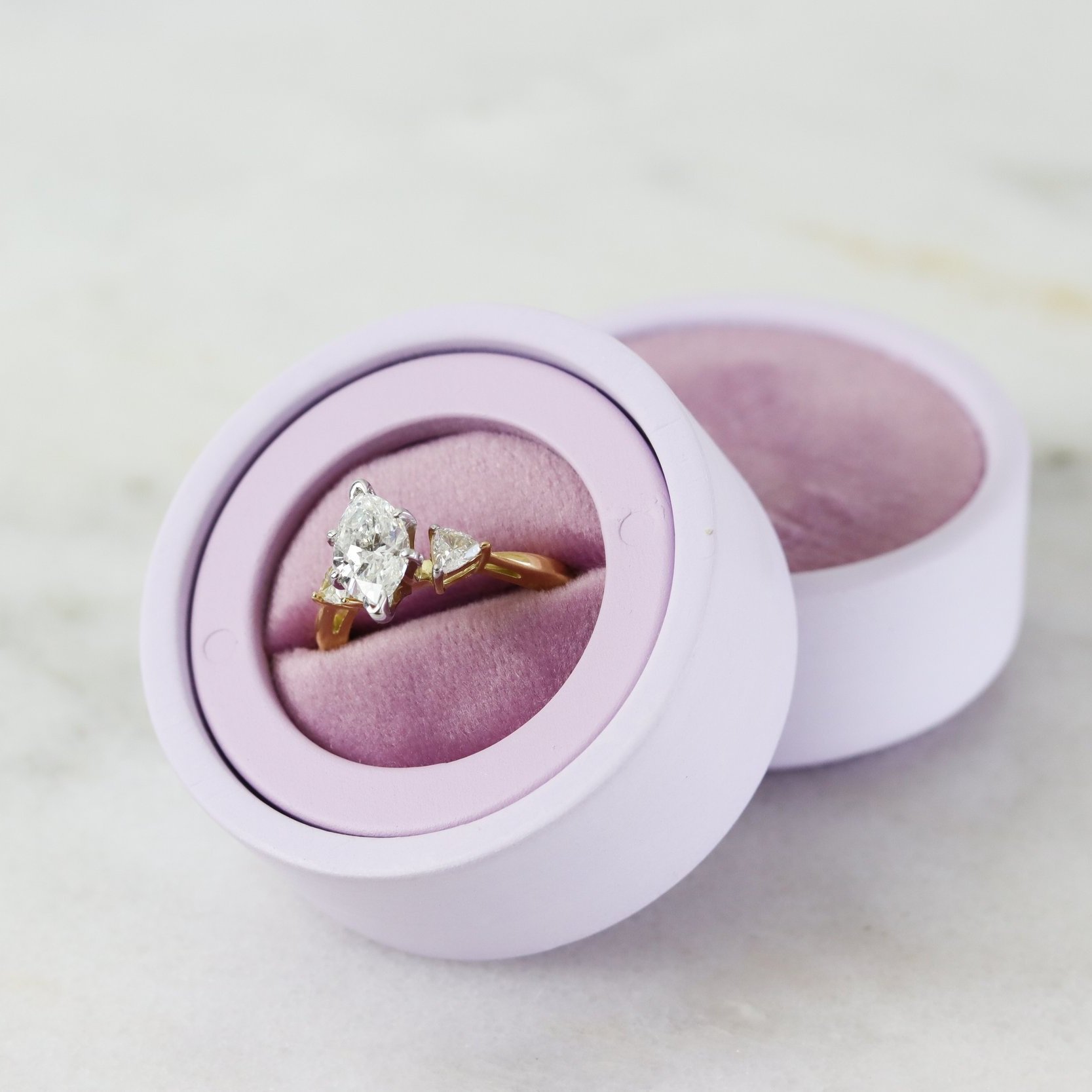 marquise engagement ring with trillion side stones in a ring box