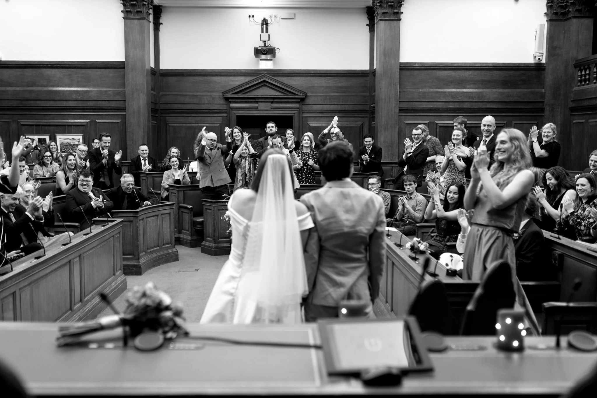 wedding guests cheer for couple after they get married