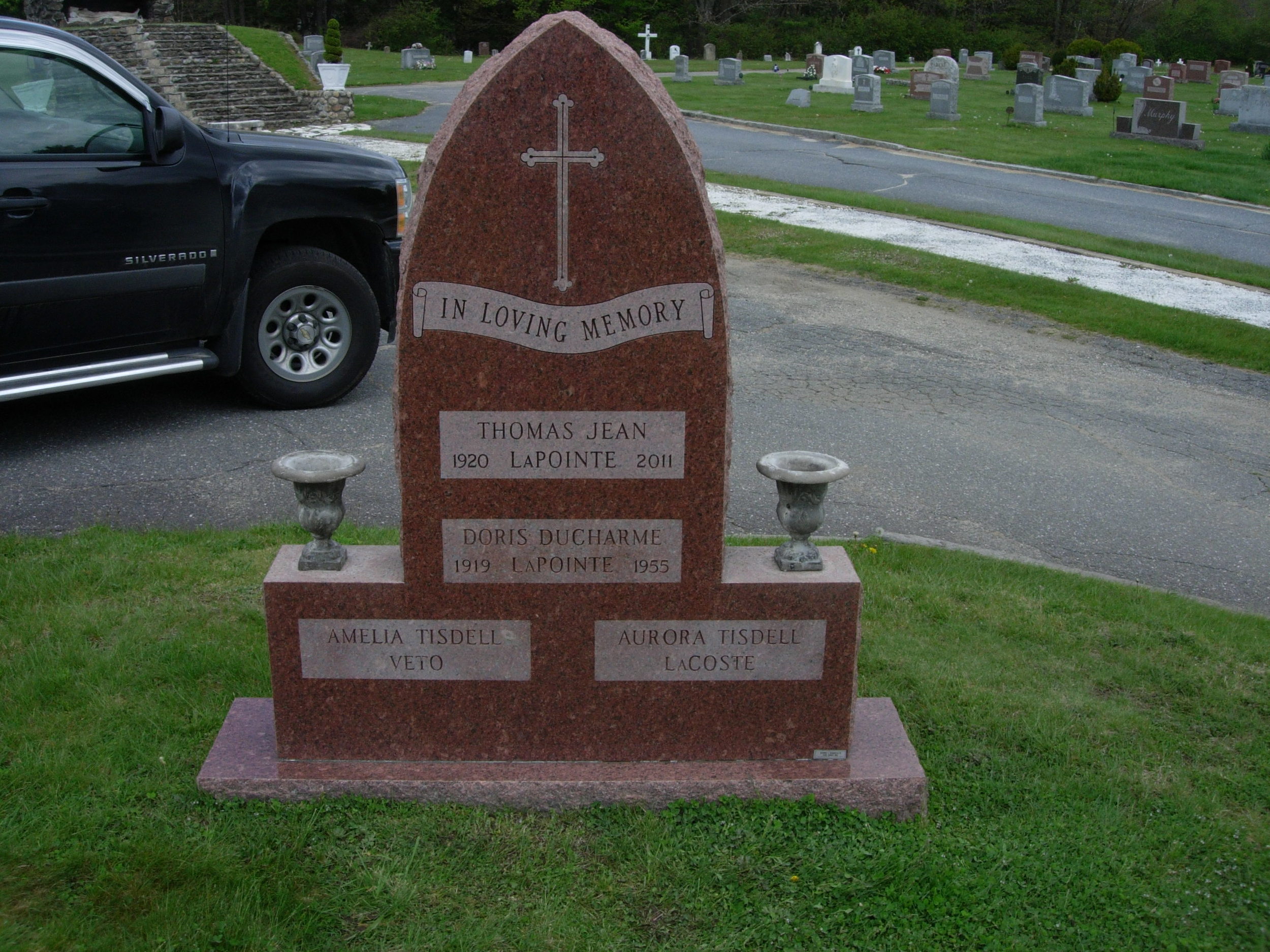 A scroll panel inscription and new name inscription with panel were added to the back of this monument to fill its space.