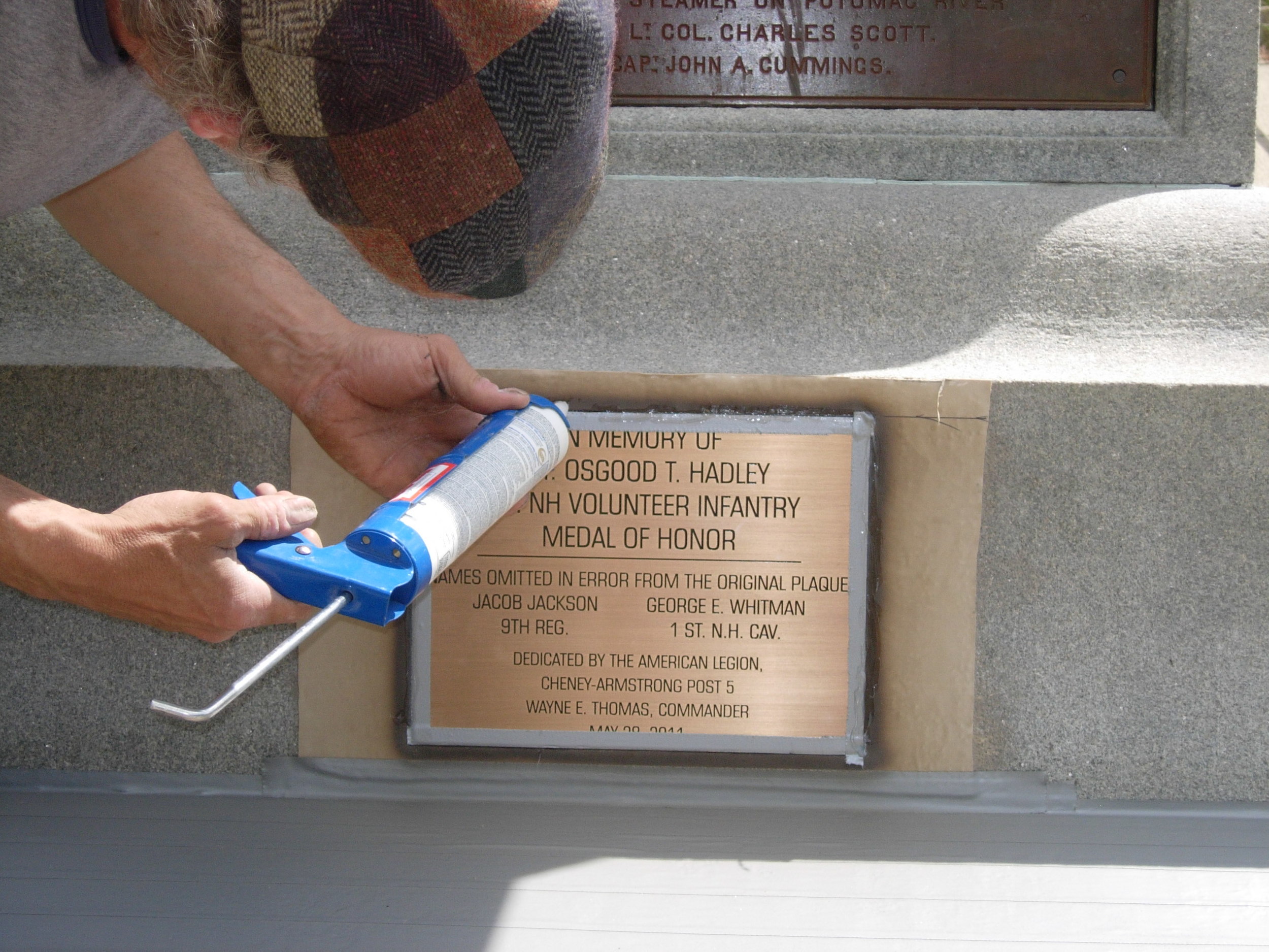 Finish caulking to seal the edges of the plaque