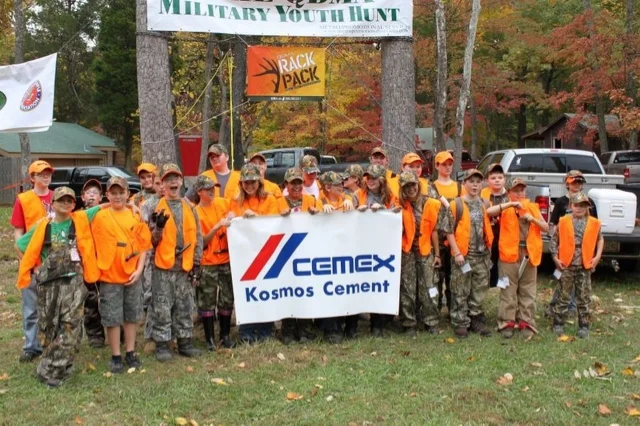 Camp Picture with CEMEX sign.jpg
