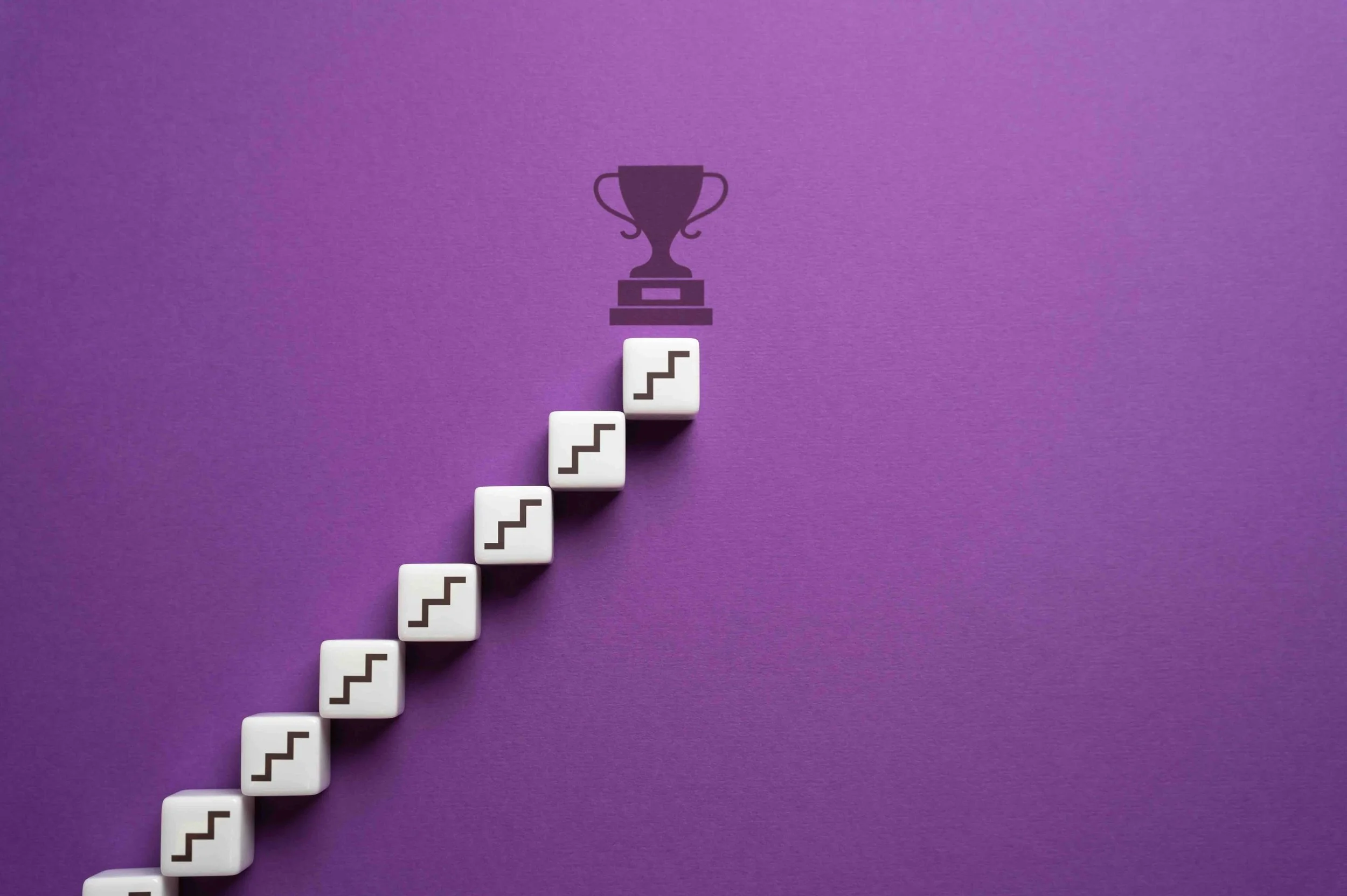 Image of steps leveling up to trophy.