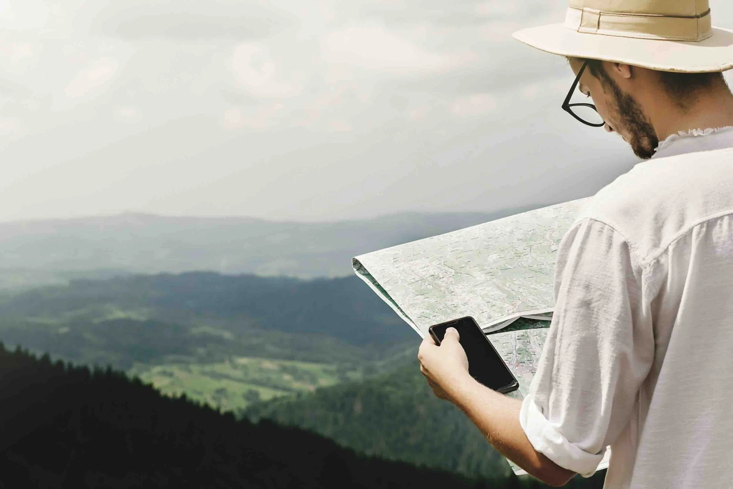 Image of explorer looking at map.