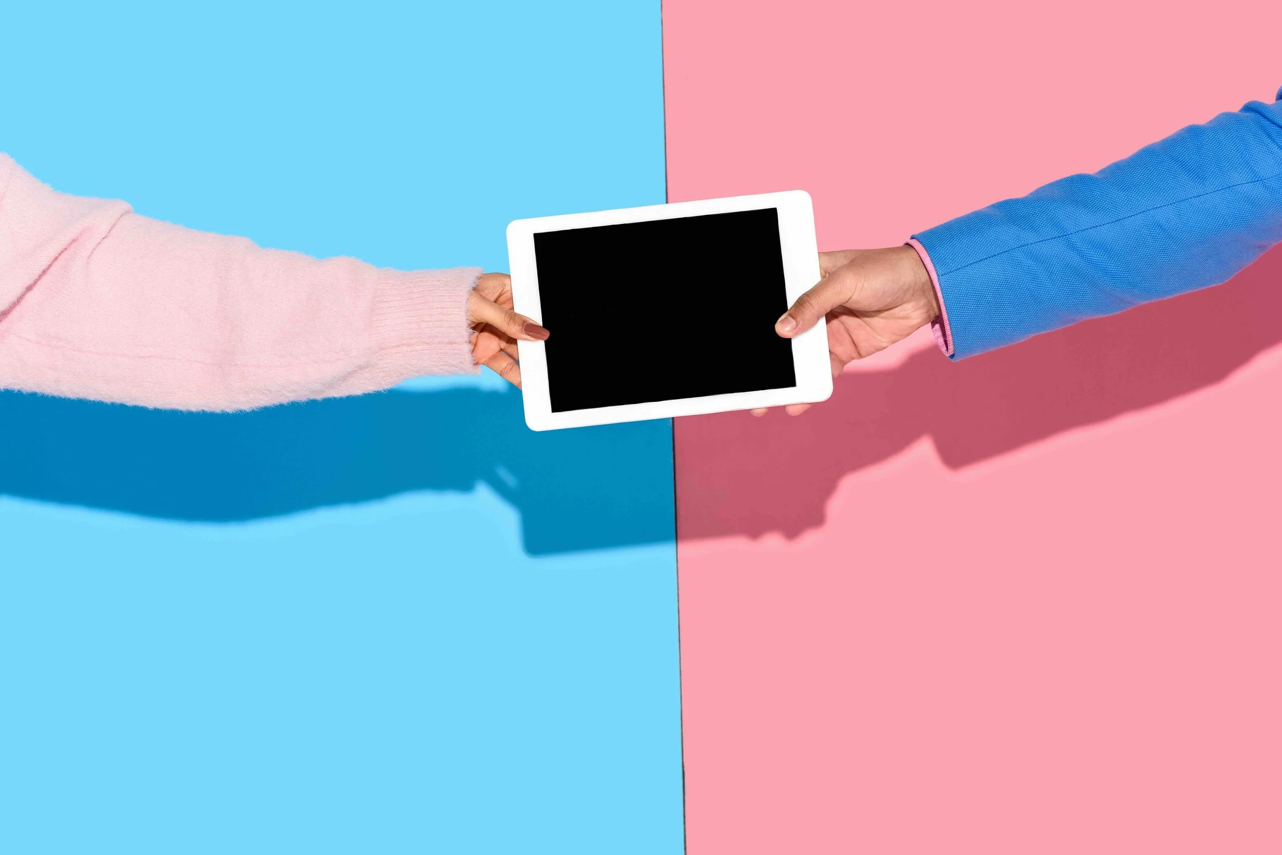 Image of hands pulling on tablet