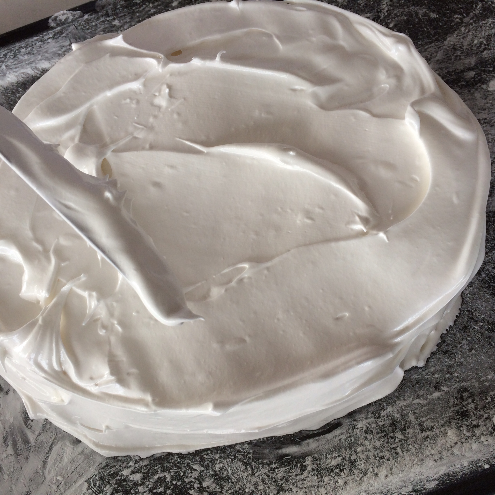 Spreading the egg white and sugar mixture onto a baking tray...