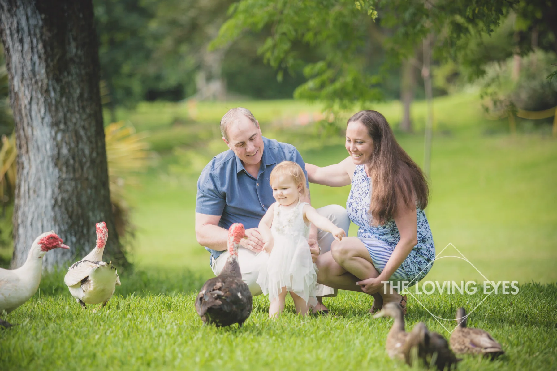 Family portrait during family vacation with ducks and geese at Hoʻomaluhia Botanical Gardens