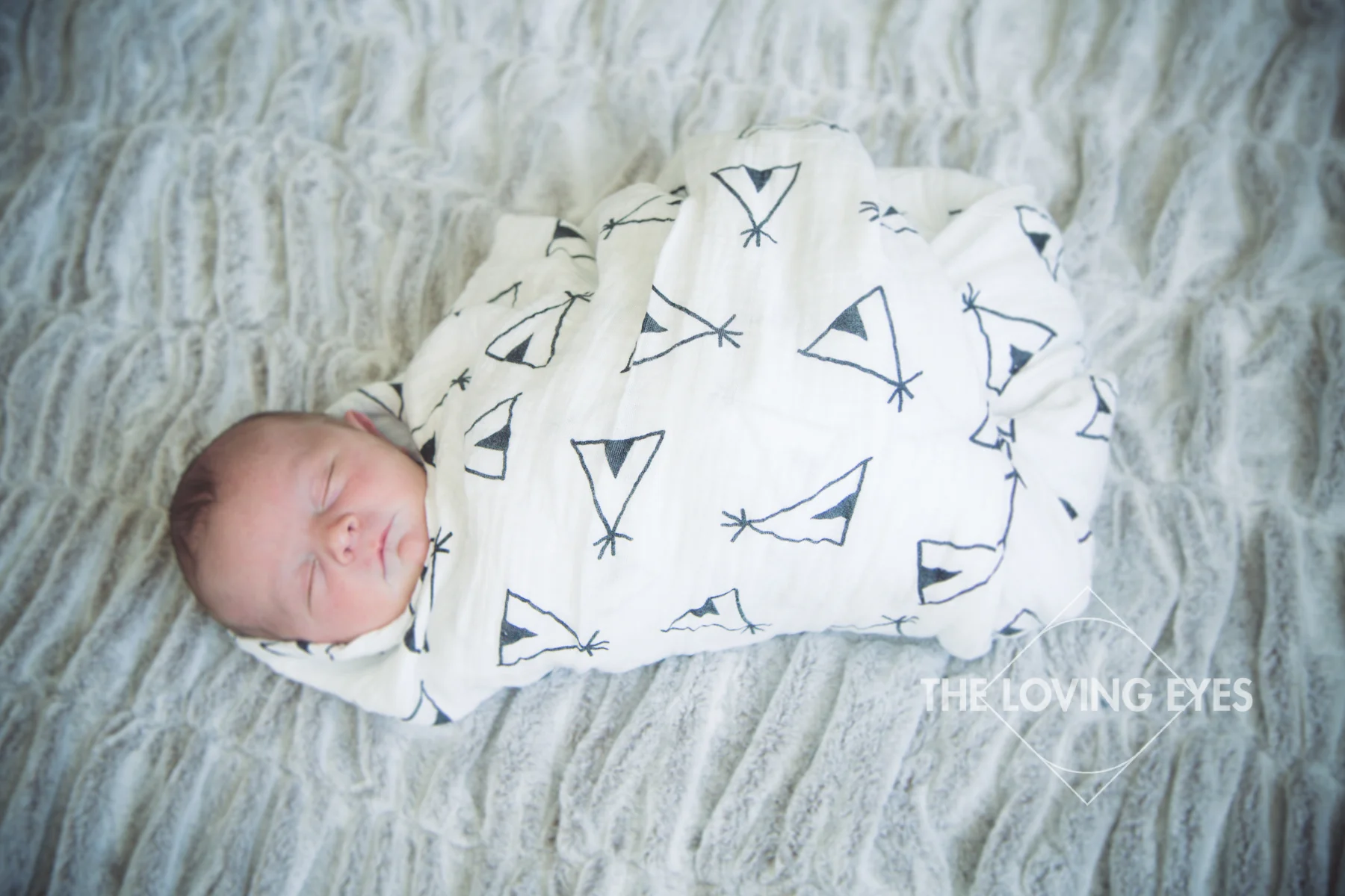 Hawaii newborn photography swaddled and sleeping baby in home with family
