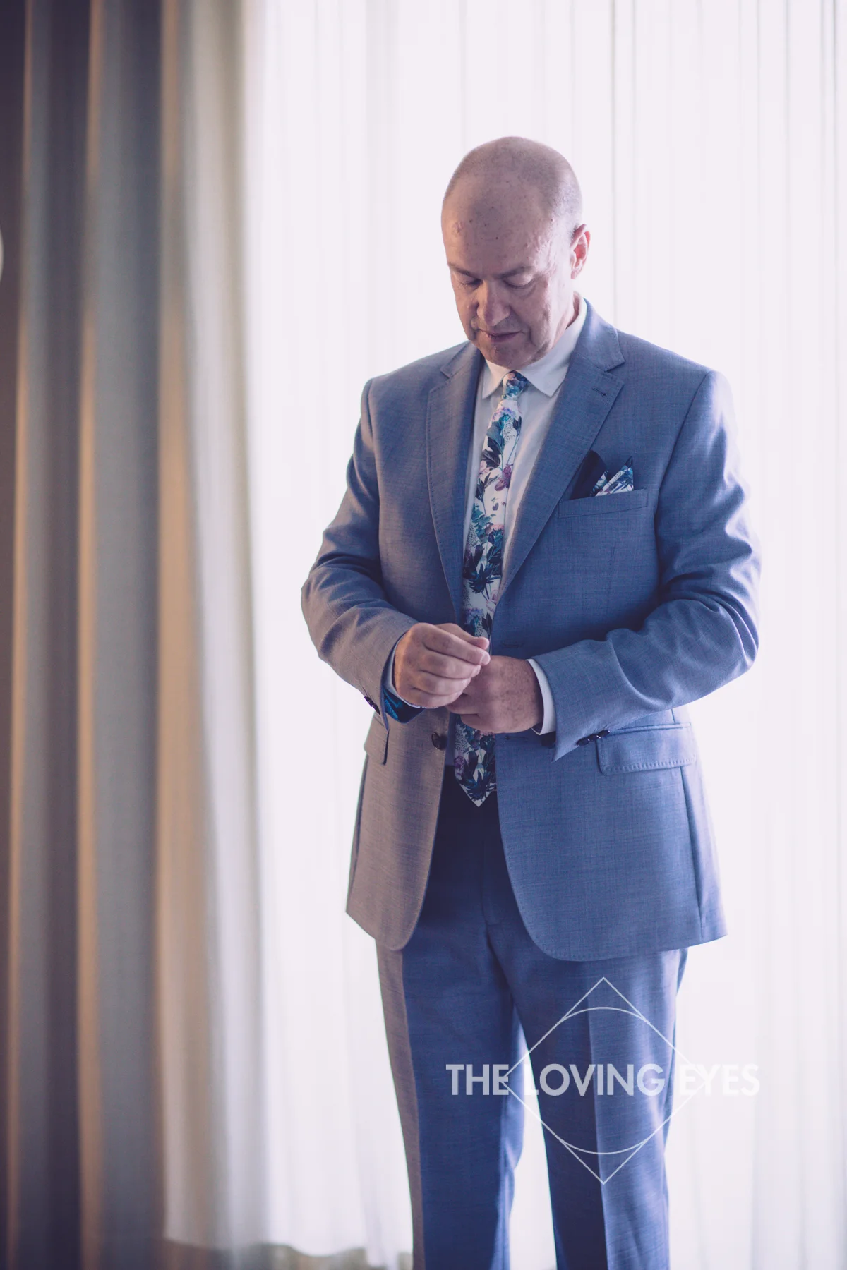Groom getting dressed for wedding ceremony in Hawaii