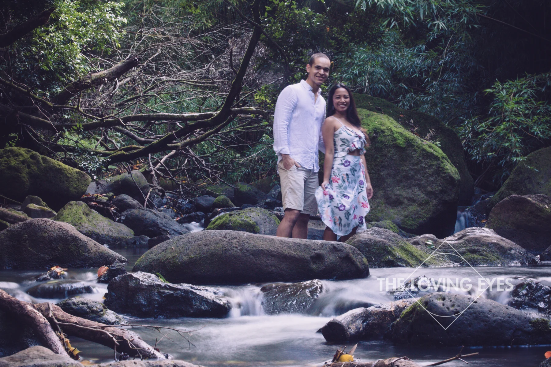 Engagement photos in a bamboo forest stream in Hawaii
