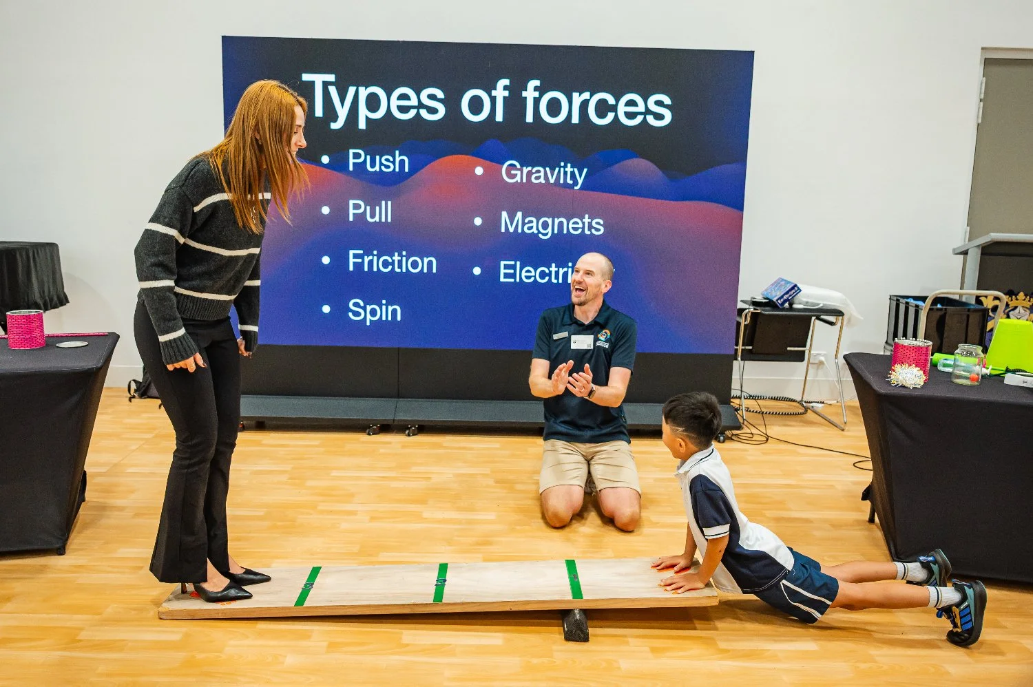 Student lifting a teacher with a giant lever