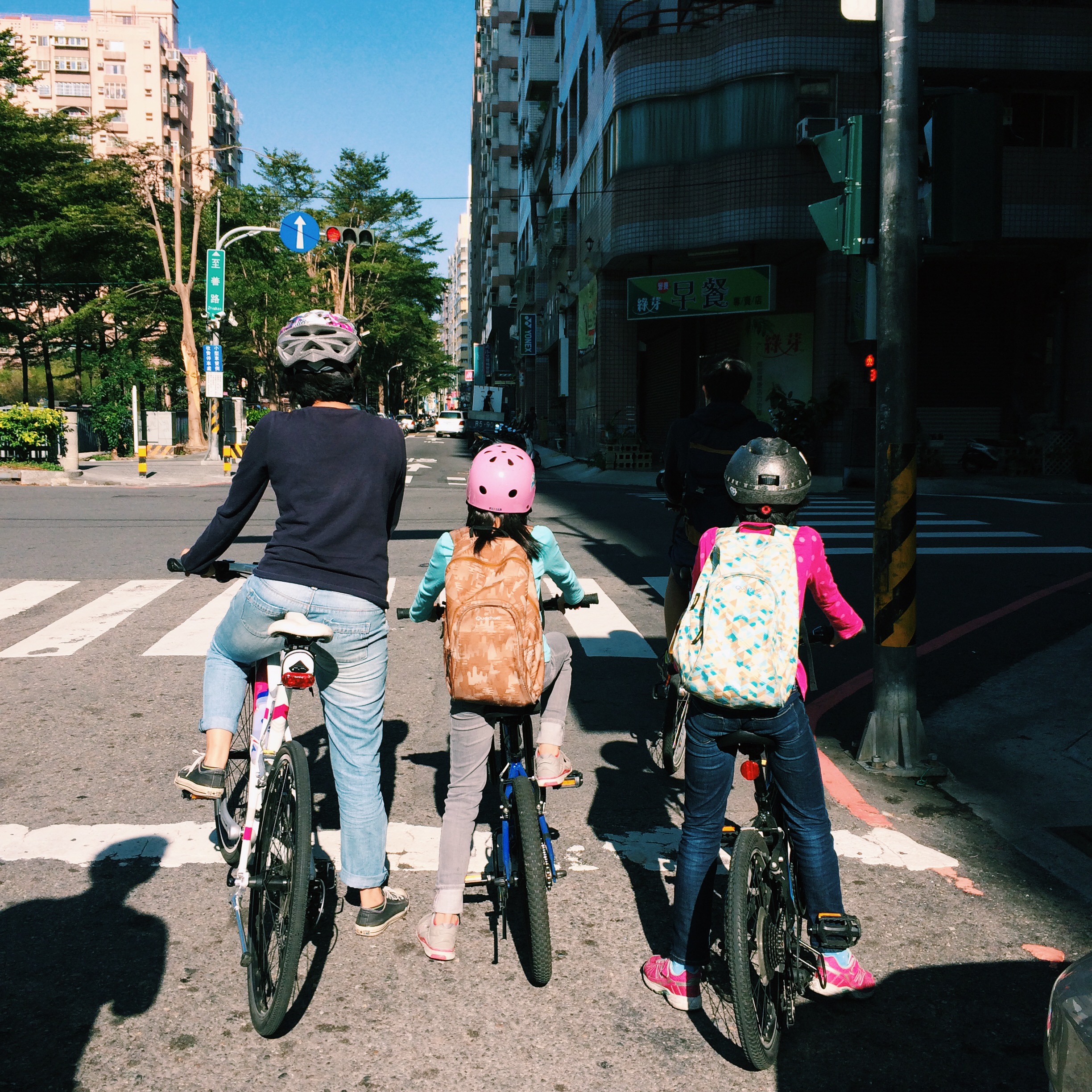 A mum riding bikes with her two daughters