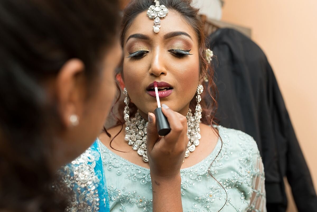 Indian Bride putting on lipsticks