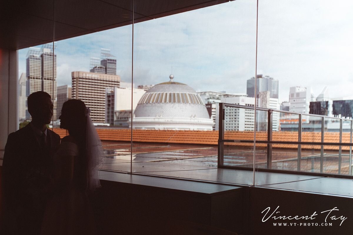 couple with cityscape behind them at Registry of Marriage Singapore