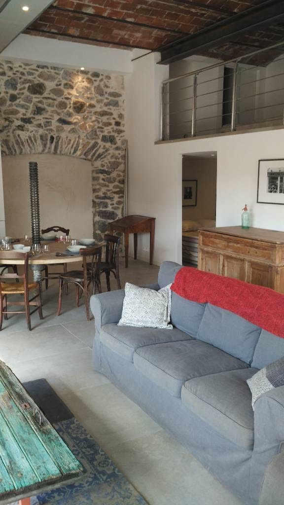 Living room with view of dining area, bedroom #1, and mezzanine #1