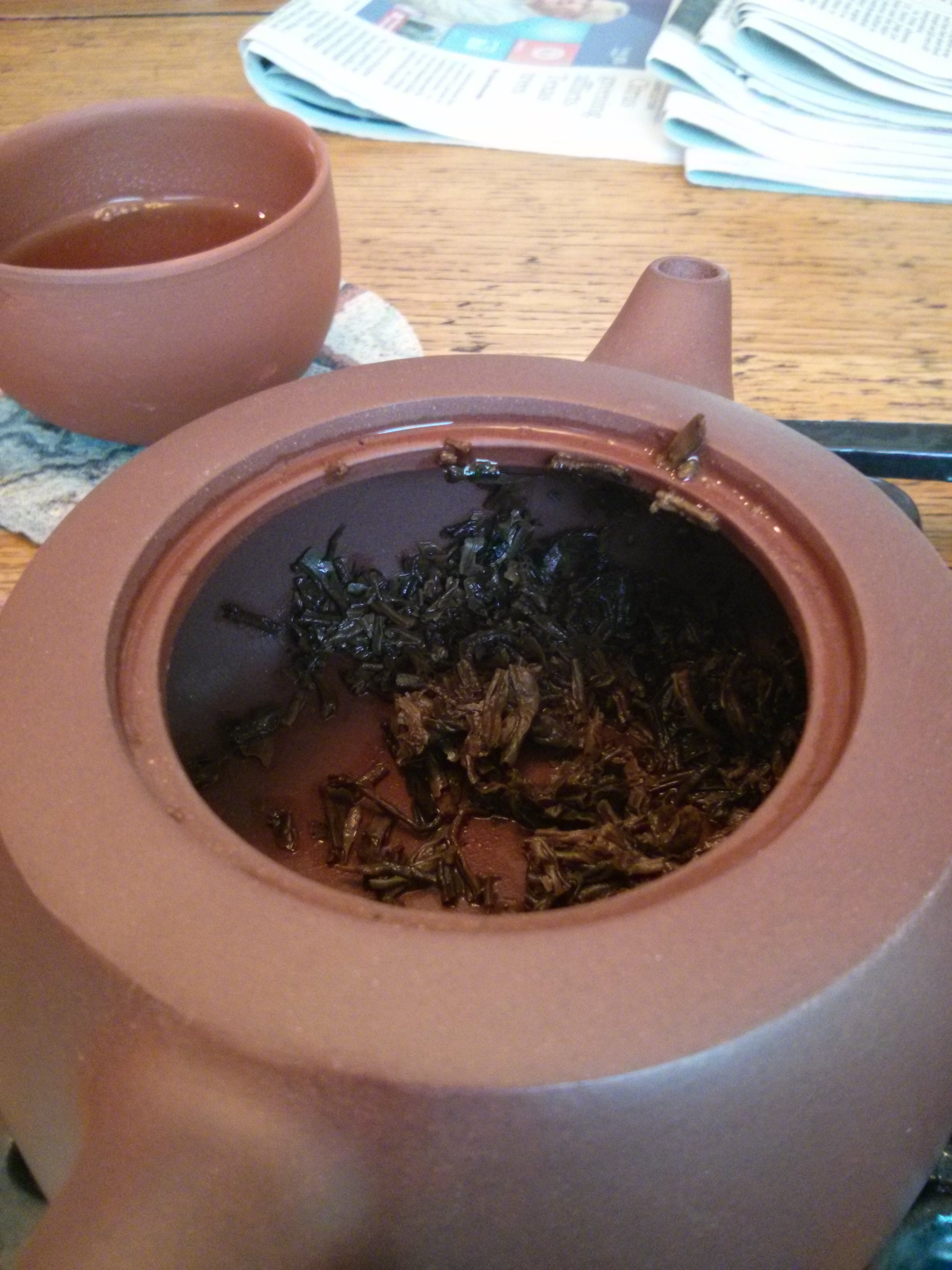 This is after the wash and first steeping (the last photo shows how this tea grows through several steepings). The first pour was still getting smaller particles out of the tea, and was originally bitter and expressed a more astringent taste. The smell of the tea overtook the room and definitely produced a calming effect.
