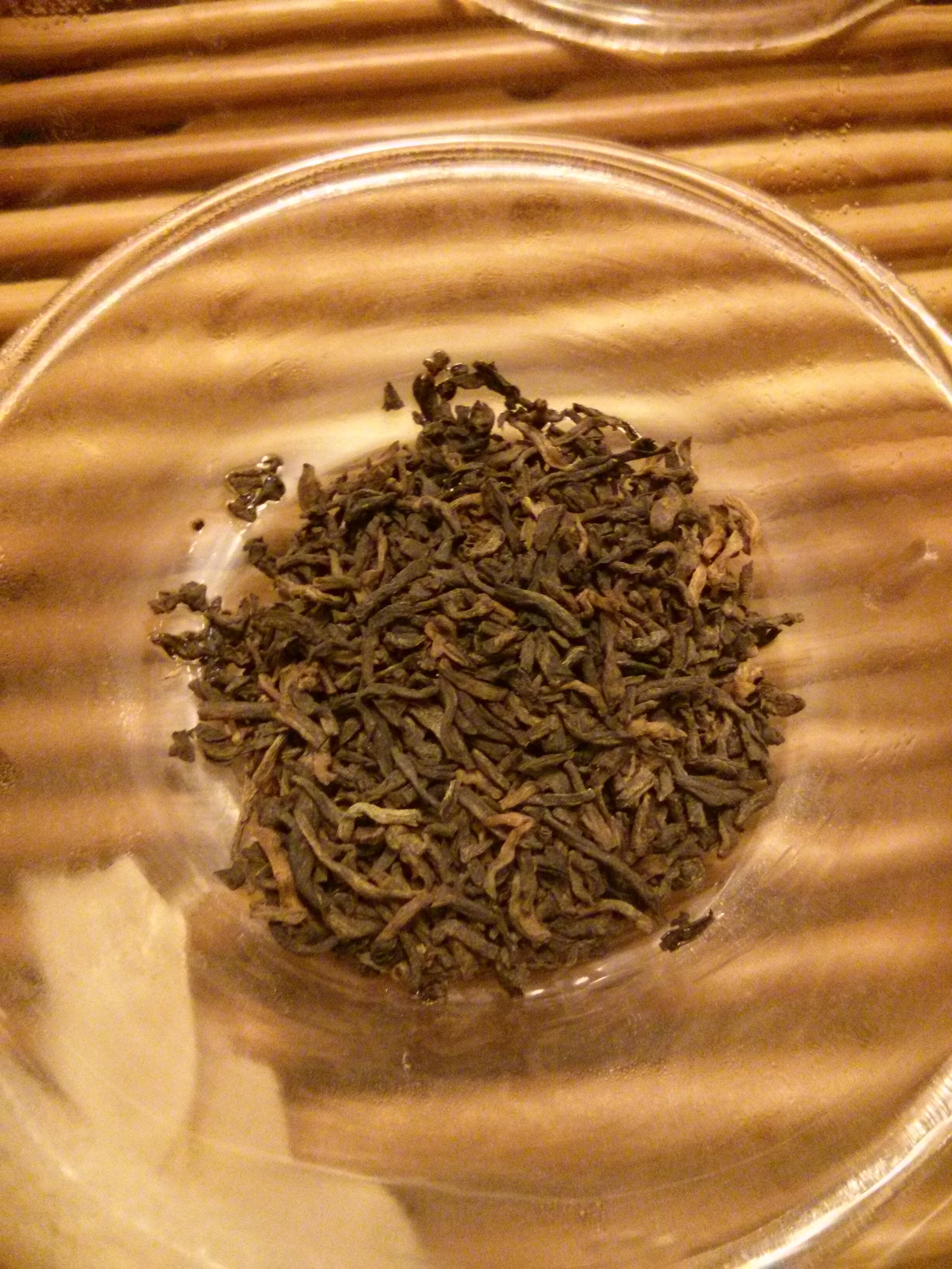 The resulting tea looked sort of like droppings of some creature. The leaves were stubby, with rounded edges. The smell of the leaves was musty, but (maybe is was due to the association) it did smell slightly citrus-y.
