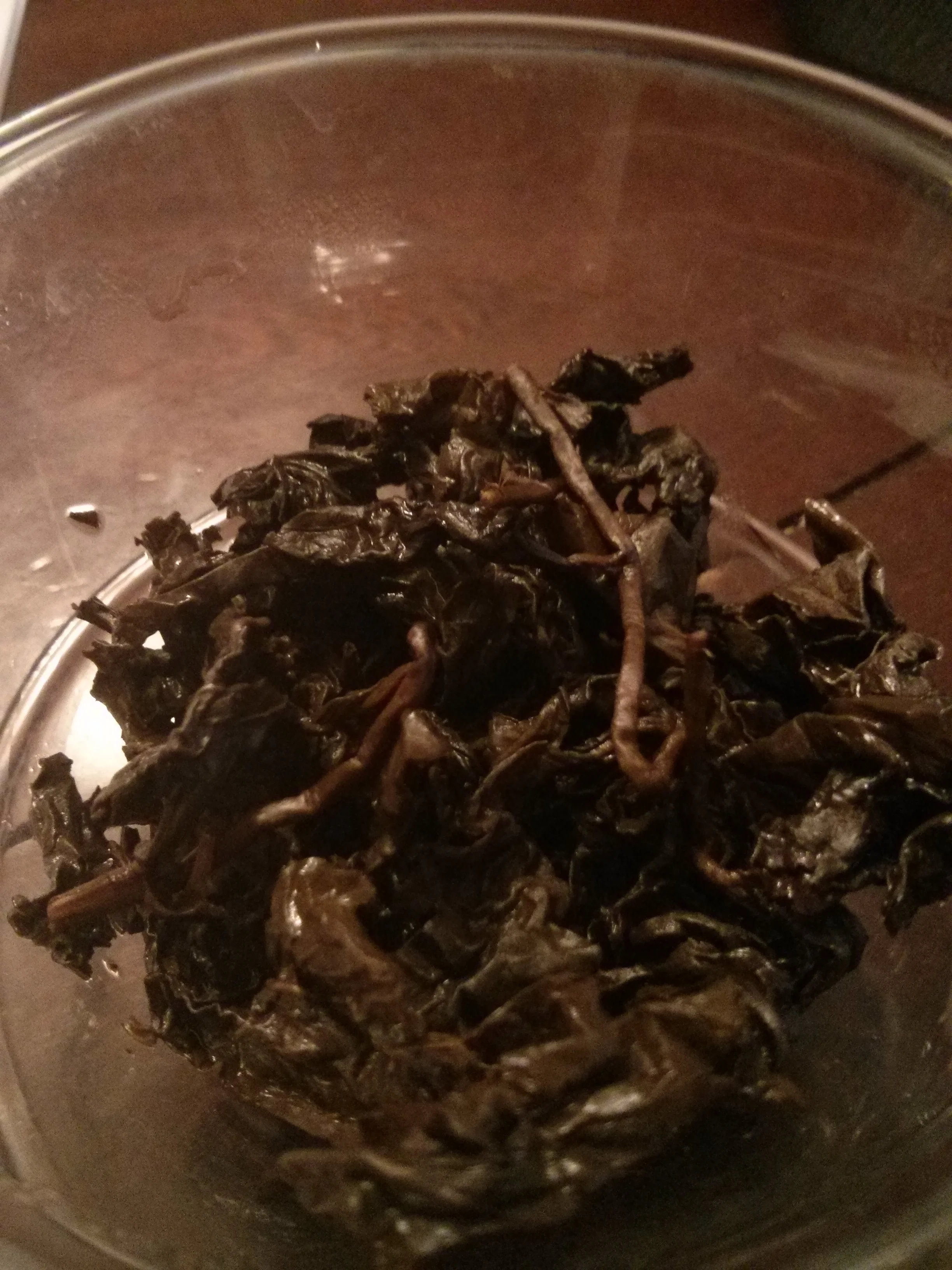 I believe this is after 5 infusions. It's incredible that these leaves and stems came from such tightly rolled oolong balls. The leaves show signs of aging, they are more kale-like and maintained a dark coloration. With other, younger roasted oolongs the leaves will still flatten out after several steepings.